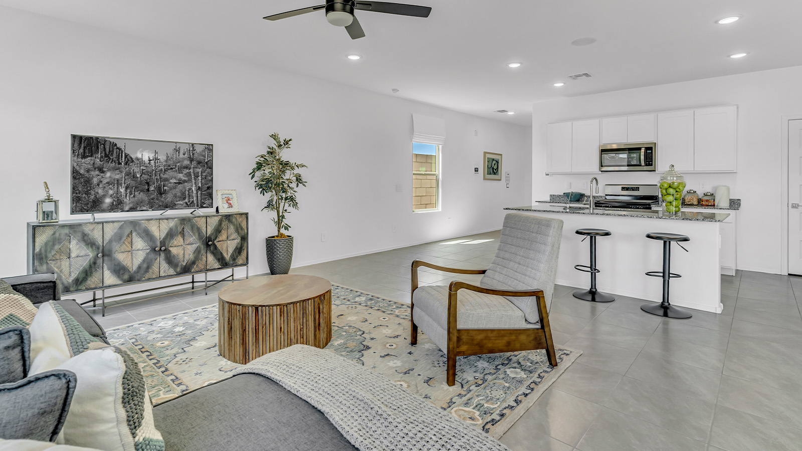 Introducing The Kate at Blackhawk in Tucson, Arizona – a spacious 2,264 sq. ft. two-story new home designed to offer both comfort and modern living in a prime location.  As you step through the inviting front porch, you’re welcomed into a thoughtfully designed entryway that leads directly into the heart of the home. The main floor boasts a generous great room that seamlessly connects to the dining area and kitchen, creating an ideal space for entertaining and everyday living. The kitchen is equipped with sleek granite countertops, a large island with a breakfast bar, modern appliances, and a pantry that provides ample storage, ensuring that the kitchen is both functional and stylish.  The main level also features a convenient powder room, perfect for guests, and direct access to the two-car garage, enhancing the home’s practicality.  Heading upstairs, you’ll discover the family’s private quarters. The master suite offers a serene retreat, complete with a spacious bedroom, a large walk-in closet, and an en-suite bathroom featuring dual vanities and a walk-in shower. The upper level also includes three additional bedrooms, a full bathroom, and a utility room centrally located for easy access. Additionally, a versatile loft area provides extra space that can be tailored to fit your lifestyle, whether as a game room, home office, or a second living area.  Step outside from the great room to the covered patio, where you can enjoy Tucson’s beautiful weather year-round. Whether you’re hosting an outdoor gathering or simply relaxing after a long day, this space extends your living area and enhances the home’s inviting ambiance.  Designed with energy efficiency in mind, The Kate at Blackhawk is a DOE Zero Energy Ready Home, combining sustainability, comfort, and long-term savings.