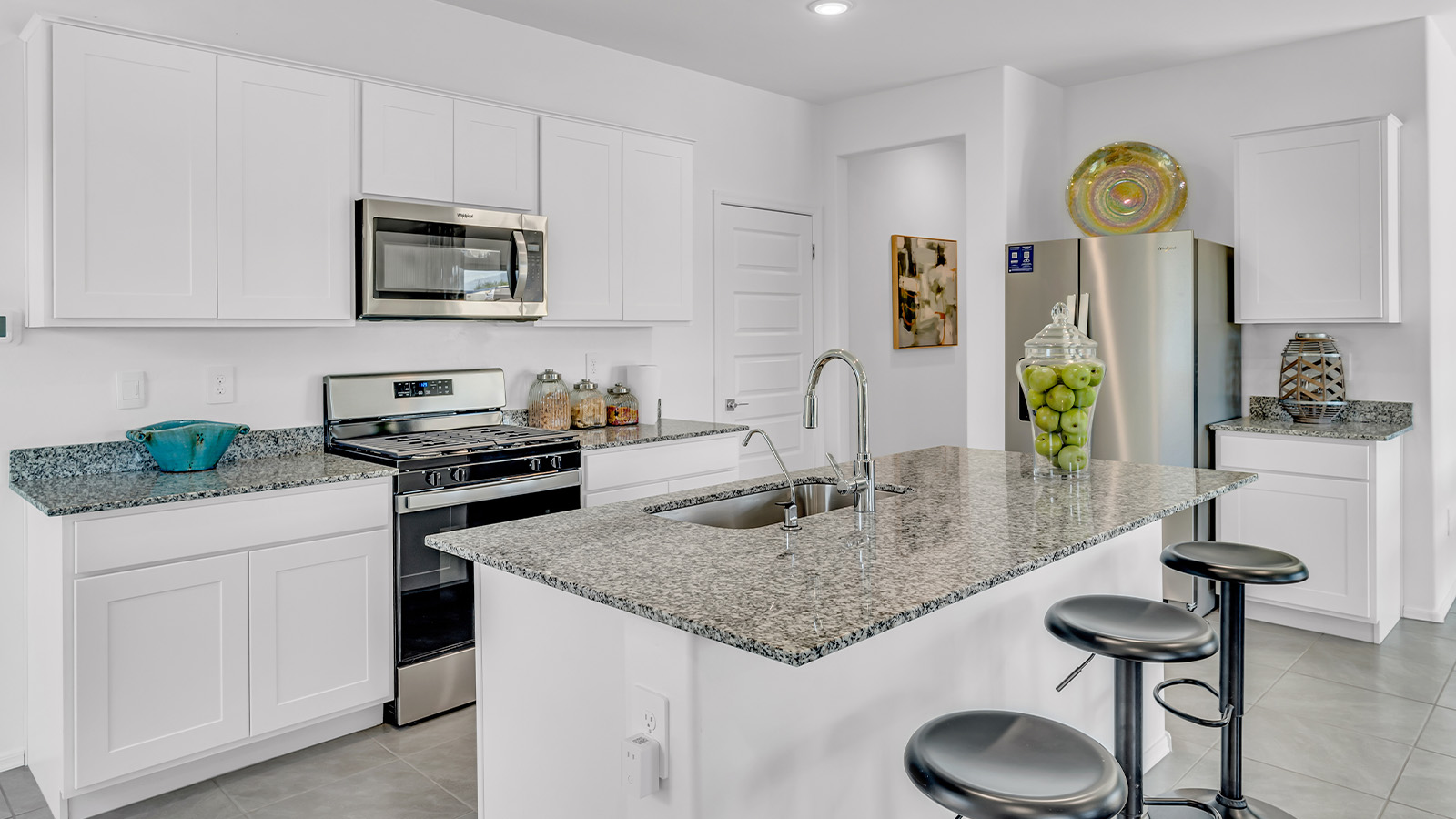 Introducing The Kate at Blackhawk in Tucson, Arizona – a spacious 2,264 sq. ft. two-story new home designed to offer both comfort and modern living in a prime location.  As you step through the inviting front porch, you’re welcomed into a thoughtfully designed entryway that leads directly into the heart of the home. The main floor boasts a generous great room that seamlessly connects to the dining area and kitchen, creating an ideal space for entertaining and everyday living. The kitchen is equipped with sleek granite countertops, a large island with a breakfast bar, modern appliances, and a pantry that provides ample storage, ensuring that the kitchen is both functional and stylish.  The main level also features a convenient powder room, perfect for guests, and direct access to the two-car garage, enhancing the home’s practicality.  Heading upstairs, you’ll discover the family’s private quarters. The master suite offers a serene retreat, complete with a spacious bedroom, a large walk-in closet, and an en-suite bathroom featuring dual vanities and a walk-in shower. The upper level also includes three additional bedrooms, a full bathroom, and a utility room centrally located for easy access. Additionally, a versatile loft area provides extra space that can be tailored to fit your lifestyle, whether as a game room, home office, or a second living area.  Step outside from the great room to the covered patio, where you can enjoy Tucson’s beautiful weather year-round. Whether you’re hosting an outdoor gathering or simply relaxing after a long day, this space extends your living area and enhances the home’s inviting ambiance.  Designed with energy efficiency in mind, The Kate at Blackhawk is a DOE Zero Energy Ready Home, combining sustainability, comfort, and long-term savings.