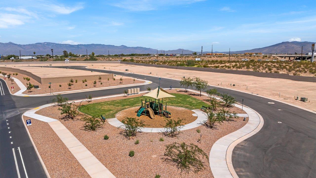 Introducing The Kate at Blackhawk in Tucson, Arizona – a spacious 2,264 sq. ft. two-story new home designed to offer both comfort and modern living in a prime location.  As you step through the inviting front porch, you’re welcomed into a thoughtfully designed entryway that leads directly into the heart of the home. The main floor boasts a generous great room that seamlessly connects to the dining area and kitchen, creating an ideal space for entertaining and everyday living. The kitchen is equipped with sleek granite countertops, a large island with a breakfast bar, modern appliances, and a pantry that provides ample storage, ensuring that the kitchen is both functional and stylish.  The main level also features a convenient powder room, perfect for guests, and direct access to the two-car garage, enhancing the home’s practicality.  Heading upstairs, you’ll discover the family’s private quarters. The master suite offers a serene retreat, complete with a spacious bedroom, a large walk-in closet, and an en-suite bathroom featuring dual vanities and a walk-in shower. The upper level also includes three additional bedrooms, a full bathroom, and a utility room centrally located for easy access. Additionally, a versatile loft area provides extra space that can be tailored to fit your lifestyle, whether as a game room, home office, or a second living area.  Step outside from the great room to the covered patio, where you can enjoy Tucson’s beautiful weather year-round. Whether you’re hosting an outdoor gathering or simply relaxing after a long day, this space extends your living area and enhances the home’s inviting ambiance.  Designed with energy efficiency in mind, The Kate at Blackhawk is a DOE Zero Energy Ready Home, combining sustainability, comfort, and long-term savings.