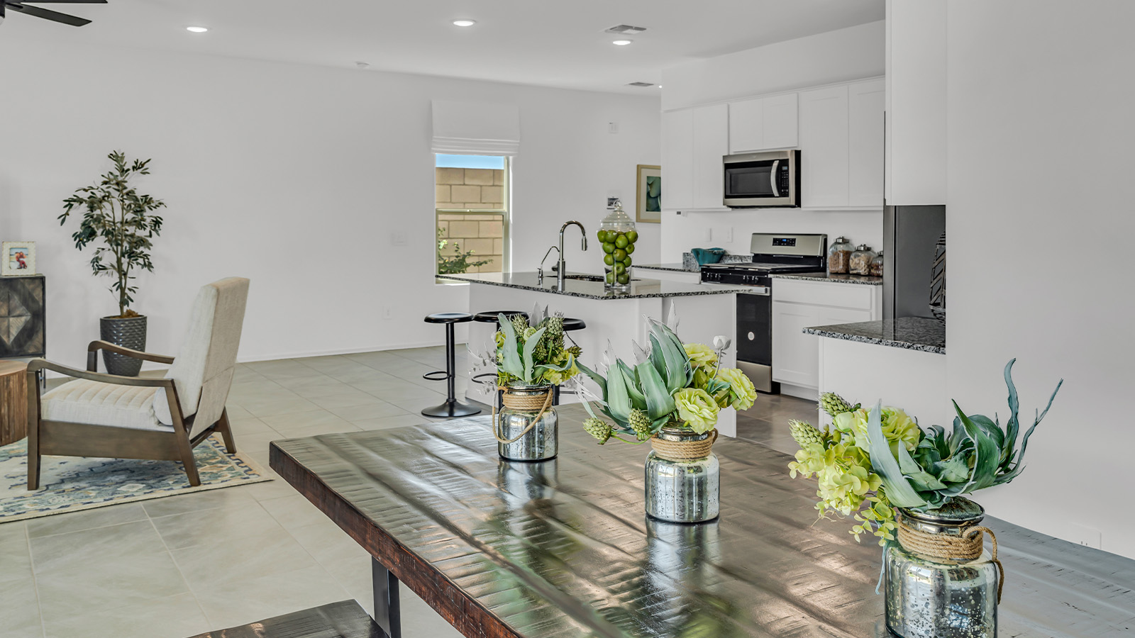 Introducing The Kate at Blackhawk in Tucson, Arizona – a spacious 2,264 sq. ft. two-story new home designed to offer both comfort and modern living in a prime location.  As you step through the inviting front porch, you’re welcomed into a thoughtfully designed entryway that leads directly into the heart of the home. The main floor boasts a generous great room that seamlessly connects to the dining area and kitchen, creating an ideal space for entertaining and everyday living. The kitchen is equipped with sleek granite countertops, a large island with a breakfast bar, modern appliances, and a pantry that provides ample storage, ensuring that the kitchen is both functional and stylish.  The main level also features a convenient powder room, perfect for guests, and direct access to the two-car garage, enhancing the home’s practicality.  Heading upstairs, you’ll discover the family’s private quarters. The master suite offers a serene retreat, complete with a spacious bedroom, a large walk-in closet, and an en-suite bathroom featuring dual vanities and a walk-in shower. The upper level also includes three additional bedrooms, a full bathroom, and a utility room centrally located for easy access. Additionally, a versatile loft area provides extra space that can be tailored to fit your lifestyle, whether as a game room, home office, or a second living area.  Step outside from the great room to the covered patio, where you can enjoy Tucson’s beautiful weather year-round. Whether you’re hosting an outdoor gathering or simply relaxing after a long day, this space extends your living area and enhances the home’s inviting ambiance.  Designed with energy efficiency in mind, The Kate at Blackhawk is a DOE Zero Energy Ready Home, combining sustainability, comfort, and long-term savings.