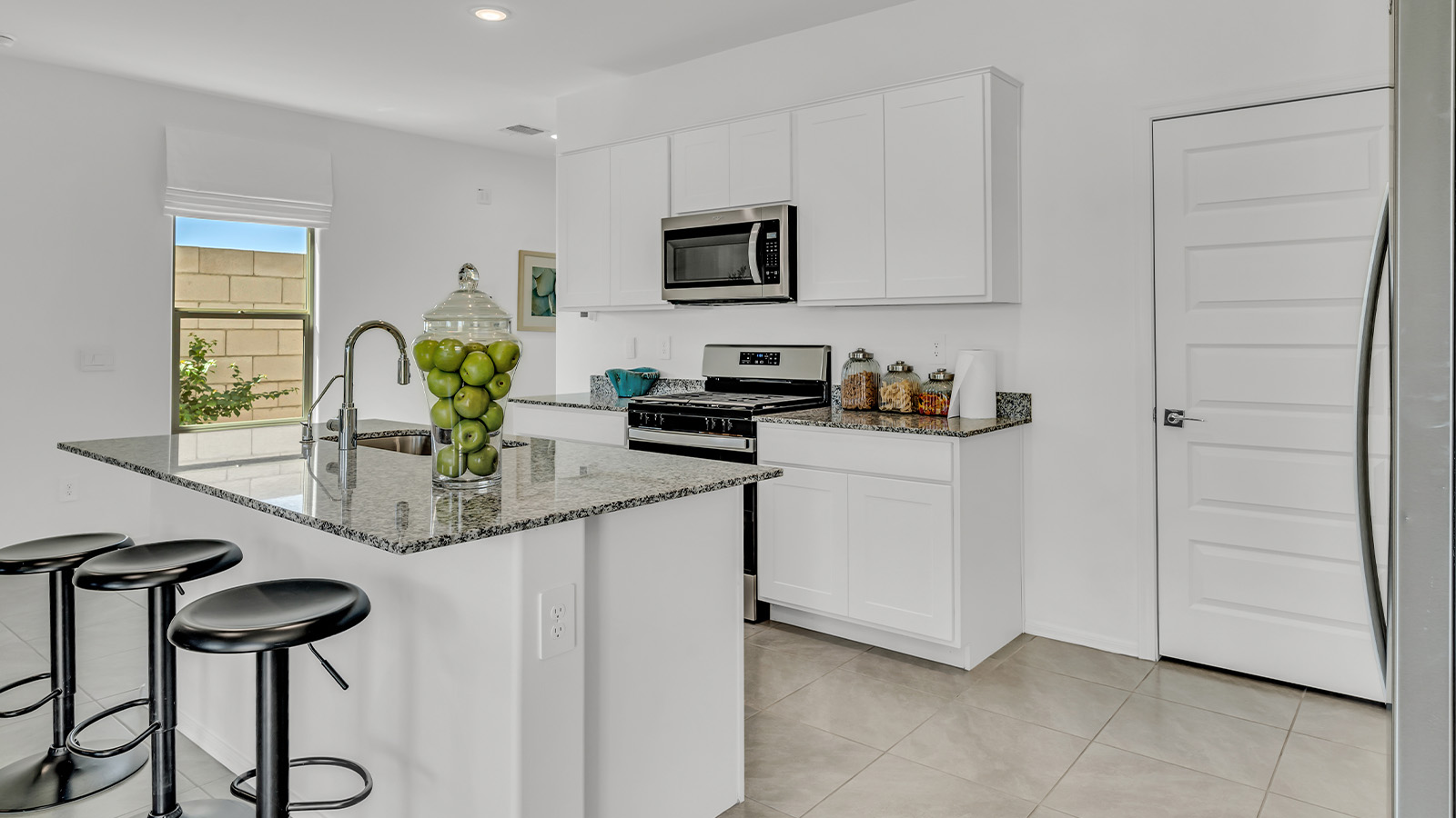 Introducing The Kate at Blackhawk in Tucson, Arizona – a spacious 2,264 sq. ft. two-story new home designed to offer both comfort and modern living in a prime location.  As you step through the inviting front porch, you’re welcomed into a thoughtfully designed entryway that leads directly into the heart of the home. The main floor boasts a generous great room that seamlessly connects to the dining area and kitchen, creating an ideal space for entertaining and everyday living. The kitchen is equipped with sleek granite countertops, a large island with a breakfast bar, modern appliances, and a pantry that provides ample storage, ensuring that the kitchen is both functional and stylish.  The main level also features a convenient powder room, perfect for guests, and direct access to the two-car garage, enhancing the home’s practicality.  Heading upstairs, you’ll discover the family’s private quarters. The master suite offers a serene retreat, complete with a spacious bedroom, a large walk-in closet, and an en-suite bathroom featuring dual vanities and a walk-in shower. The upper level also includes three additional bedrooms, a full bathroom, and a utility room centrally located for easy access. Additionally, a versatile loft area provides extra space that can be tailored to fit your lifestyle, whether as a game room, home office, or a second living area.  Step outside from the great room to the covered patio, where you can enjoy Tucson’s beautiful weather year-round. Whether you’re hosting an outdoor gathering or simply relaxing after a long day, this space extends your living area and enhances the home’s inviting ambiance.  Designed with energy efficiency in mind, The Kate at Blackhawk is a DOE Zero Energy Ready Home, combining sustainability, comfort, and long-term savings.