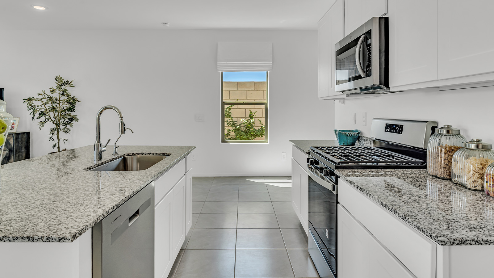 Introducing The Kate at Blackhawk in Tucson, Arizona – a spacious 2,264 sq. ft. two-story new home designed to offer both comfort and modern living in a prime location.  As you step through the inviting front porch, you’re welcomed into a thoughtfully designed entryway that leads directly into the heart of the home. The main floor boasts a generous great room that seamlessly connects to the dining area and kitchen, creating an ideal space for entertaining and everyday living. The kitchen is equipped with sleek granite countertops, a large island with a breakfast bar, modern appliances, and a pantry that provides ample storage, ensuring that the kitchen is both functional and stylish.  The main level also features a convenient powder room, perfect for guests, and direct access to the two-car garage, enhancing the home’s practicality.  Heading upstairs, you’ll discover the family’s private quarters. The master suite offers a serene retreat, complete with a spacious bedroom, a large walk-in closet, and an en-suite bathroom featuring dual vanities and a walk-in shower. The upper level also includes three additional bedrooms, a full bathroom, and a utility room centrally located for easy access. Additionally, a versatile loft area provides extra space that can be tailored to fit your lifestyle, whether as a game room, home office, or a second living area.  Step outside from the great room to the covered patio, where you can enjoy Tucson’s beautiful weather year-round. Whether you’re hosting an outdoor gathering or simply relaxing after a long day, this space extends your living area and enhances the home’s inviting ambiance.  Designed with energy efficiency in mind, The Kate at Blackhawk is a DOE Zero Energy Ready Home, combining sustainability, comfort, and long-term savings.