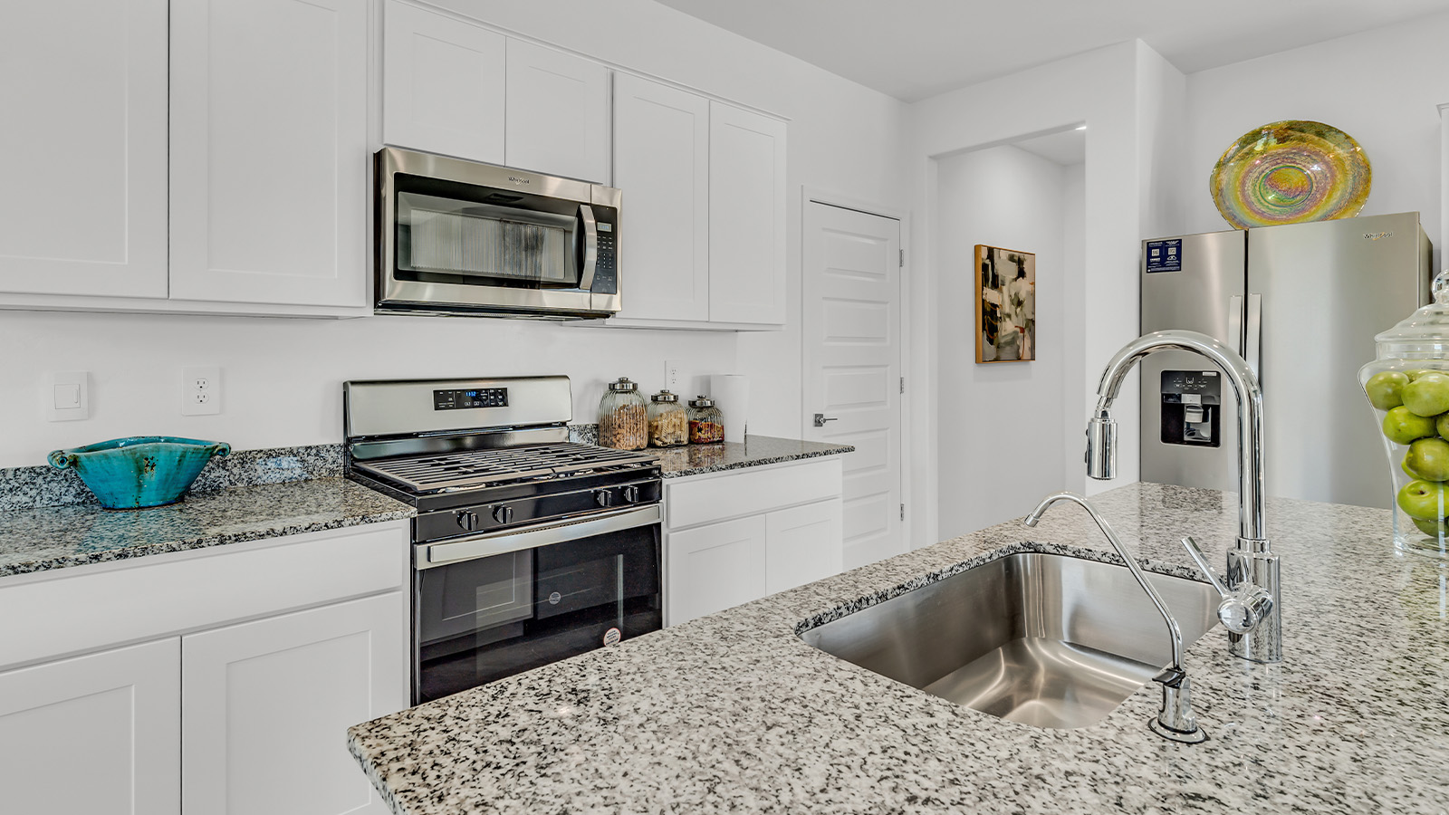 Introducing The Kate at Blackhawk in Tucson, Arizona – a spacious 2,264 sq. ft. two-story new home designed to offer both comfort and modern living in a prime location.  As you step through the inviting front porch, you’re welcomed into a thoughtfully designed entryway that leads directly into the heart of the home. The main floor boasts a generous great room that seamlessly connects to the dining area and kitchen, creating an ideal space for entertaining and everyday living. The kitchen is equipped with sleek granite countertops, a large island with a breakfast bar, modern appliances, and a pantry that provides ample storage, ensuring that the kitchen is both functional and stylish.  The main level also features a convenient powder room, perfect for guests, and direct access to the two-car garage, enhancing the home’s practicality.  Heading upstairs, you’ll discover the family’s private quarters. The master suite offers a serene retreat, complete with a spacious bedroom, a large walk-in closet, and an en-suite bathroom featuring dual vanities and a walk-in shower. The upper level also includes three additional bedrooms, a full bathroom, and a utility room centrally located for easy access. Additionally, a versatile loft area provides extra space that can be tailored to fit your lifestyle, whether as a game room, home office, or a second living area.  Step outside from the great room to the covered patio, where you can enjoy Tucson’s beautiful weather year-round. Whether you’re hosting an outdoor gathering or simply relaxing after a long day, this space extends your living area and enhances the home’s inviting ambiance.  Designed with energy efficiency in mind, The Kate at Blackhawk is a DOE Zero Energy Ready Home, combining sustainability, comfort, and long-term savings.