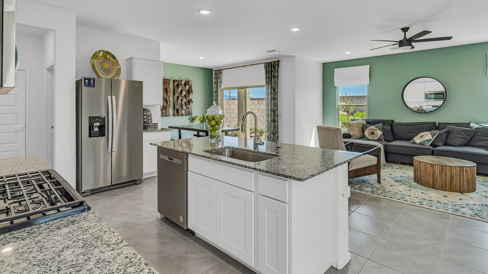 Introducing The Kate at Blackhawk in Tucson, Arizona – a spacious 2,264 sq. ft. two-story new home designed to offer both comfort and modern living in a prime location.  As you step through the inviting front porch, you’re welcomed into a thoughtfully designed entryway that leads directly into the heart of the home. The main floor boasts a generous great room that seamlessly connects to the dining area and kitchen, creating an ideal space for entertaining and everyday living. The kitchen is equipped with sleek granite countertops, a large island with a breakfast bar, modern appliances, and a pantry that provides ample storage, ensuring that the kitchen is both functional and stylish.  The main level also features a convenient powder room, perfect for guests, and direct access to the two-car garage, enhancing the home’s practicality.  Heading upstairs, you’ll discover the family’s private quarters. The master suite offers a serene retreat, complete with a spacious bedroom, a large walk-in closet, and an en-suite bathroom featuring dual vanities and a walk-in shower. The upper level also includes three additional bedrooms, a full bathroom, and a utility room centrally located for easy access. Additionally, a versatile loft area provides extra space that can be tailored to fit your lifestyle, whether as a game room, home office, or a second living area.  Step outside from the great room to the covered patio, where you can enjoy Tucson’s beautiful weather year-round. Whether you’re hosting an outdoor gathering or simply relaxing after a long day, this space extends your living area and enhances the home’s inviting ambiance.  Designed with energy efficiency in mind, The Kate at Blackhawk is a DOE Zero Energy Ready Home, combining sustainability, comfort, and long-term savings.