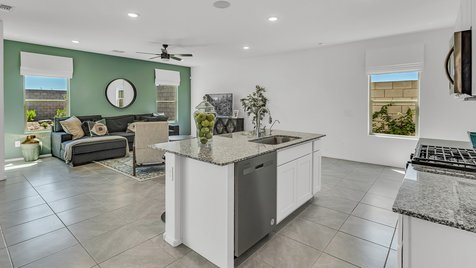 Introducing The Kate at Blackhawk in Tucson, Arizona – a spacious 2,264 sq. ft. two-story new home designed to offer both comfort and modern living in a prime location.  As you step through the inviting front porch, you’re welcomed into a thoughtfully designed entryway that leads directly into the heart of the home. The main floor boasts a generous great room that seamlessly connects to the dining area and kitchen, creating an ideal space for entertaining and everyday living. The kitchen is equipped with sleek granite countertops, a large island with a breakfast bar, modern appliances, and a pantry that provides ample storage, ensuring that the kitchen is both functional and stylish.  The main level also features a convenient powder room, perfect for guests, and direct access to the two-car garage, enhancing the home’s practicality.  Heading upstairs, you’ll discover the family’s private quarters. The master suite offers a serene retreat, complete with a spacious bedroom, a large walk-in closet, and an en-suite bathroom featuring dual vanities and a walk-in shower. The upper level also includes three additional bedrooms, a full bathroom, and a utility room centrally located for easy access. Additionally, a versatile loft area provides extra space that can be tailored to fit your lifestyle, whether as a game room, home office, or a second living area.  Step outside from the great room to the covered patio, where you can enjoy Tucson’s beautiful weather year-round. Whether you’re hosting an outdoor gathering or simply relaxing after a long day, this space extends your living area and enhances the home’s inviting ambiance.  Designed with energy efficiency in mind, The Kate at Blackhawk is a DOE Zero Energy Ready Home, combining sustainability, comfort, and long-term savings.