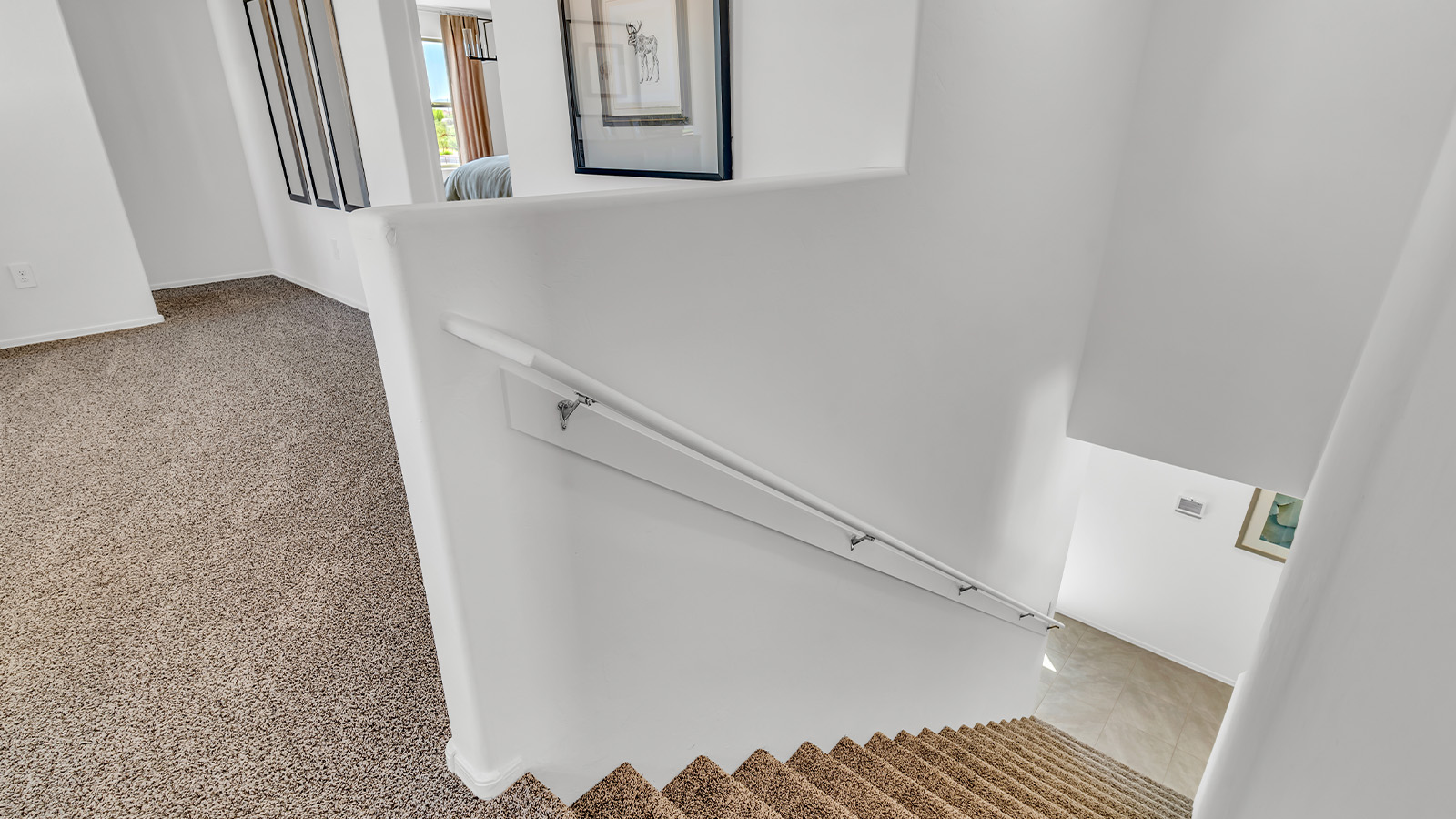 Introducing The Kate at Blackhawk in Tucson, Arizona – a spacious 2,264 sq. ft. two-story new home designed to offer both comfort and modern living in a prime location.  As you step through the inviting front porch, you’re welcomed into a thoughtfully designed entryway that leads directly into the heart of the home. The main floor boasts a generous great room that seamlessly connects to the dining area and kitchen, creating an ideal space for entertaining and everyday living. The kitchen is equipped with sleek granite countertops, a large island with a breakfast bar, modern appliances, and a pantry that provides ample storage, ensuring that the kitchen is both functional and stylish.  The main level also features a convenient powder room, perfect for guests, and direct access to the two-car garage, enhancing the home’s practicality.  Heading upstairs, you’ll discover the family’s private quarters. The master suite offers a serene retreat, complete with a spacious bedroom, a large walk-in closet, and an en-suite bathroom featuring dual vanities and a walk-in shower. The upper level also includes three additional bedrooms, a full bathroom, and a utility room centrally located for easy access. Additionally, a versatile loft area provides extra space that can be tailored to fit your lifestyle, whether as a game room, home office, or a second living area.  Step outside from the great room to the covered patio, where you can enjoy Tucson’s beautiful weather year-round. Whether you’re hosting an outdoor gathering or simply relaxing after a long day, this space extends your living area and enhances the home’s inviting ambiance.  Designed with energy efficiency in mind, The Kate at Blackhawk is a DOE Zero Energy Ready Home, combining sustainability, comfort, and long-term savings.