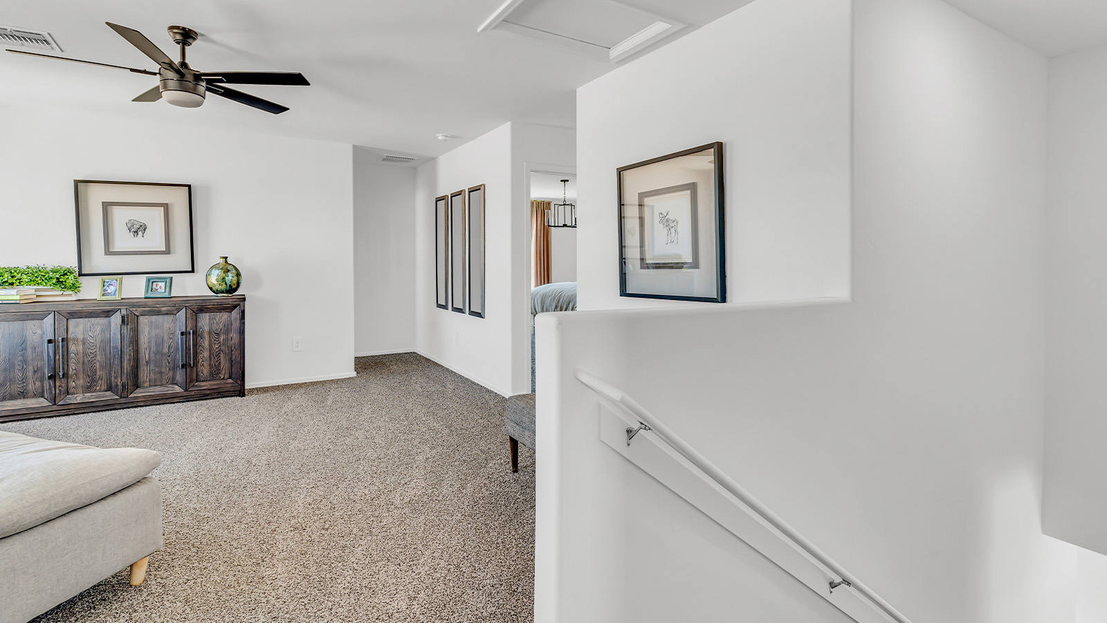 Introducing The Kate at Blackhawk in Tucson, Arizona – a spacious 2,264 sq. ft. two-story new home designed to offer both comfort and modern living in a prime location.  As you step through the inviting front porch, you’re welcomed into a thoughtfully designed entryway that leads directly into the heart of the home. The main floor boasts a generous great room that seamlessly connects to the dining area and kitchen, creating an ideal space for entertaining and everyday living. The kitchen is equipped with sleek granite countertops, a large island with a breakfast bar, modern appliances, and a pantry that provides ample storage, ensuring that the kitchen is both functional and stylish.  The main level also features a convenient powder room, perfect for guests, and direct access to the two-car garage, enhancing the home’s practicality.  Heading upstairs, you’ll discover the family’s private quarters. The master suite offers a serene retreat, complete with a spacious bedroom, a large walk-in closet, and an en-suite bathroom featuring dual vanities and a walk-in shower. The upper level also includes three additional bedrooms, a full bathroom, and a utility room centrally located for easy access. Additionally, a versatile loft area provides extra space that can be tailored to fit your lifestyle, whether as a game room, home office, or a second living area.  Step outside from the great room to the covered patio, where you can enjoy Tucson’s beautiful weather year-round. Whether you’re hosting an outdoor gathering or simply relaxing after a long day, this space extends your living area and enhances the home’s inviting ambiance.  Designed with energy efficiency in mind, The Kate at Blackhawk is a DOE Zero Energy Ready Home, combining sustainability, comfort, and long-term savings.