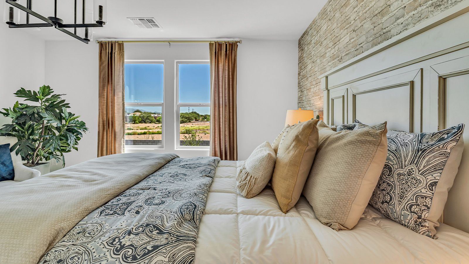 Introducing The Kate at Blackhawk in Tucson, Arizona – a spacious 2,264 sq. ft. two-story new home designed to offer both comfort and modern living in a prime location.  As you step through the inviting front porch, you’re welcomed into a thoughtfully designed entryway that leads directly into the heart of the home. The main floor boasts a generous great room that seamlessly connects to the dining area and kitchen, creating an ideal space for entertaining and everyday living. The kitchen is equipped with sleek granite countertops, a large island with a breakfast bar, modern appliances, and a pantry that provides ample storage, ensuring that the kitchen is both functional and stylish.  The main level also features a convenient powder room, perfect for guests, and direct access to the two-car garage, enhancing the home’s practicality.  Heading upstairs, you’ll discover the family’s private quarters. The master suite offers a serene retreat, complete with a spacious bedroom, a large walk-in closet, and an en-suite bathroom featuring dual vanities and a walk-in shower. The upper level also includes three additional bedrooms, a full bathroom, and a utility room centrally located for easy access. Additionally, a versatile loft area provides extra space that can be tailored to fit your lifestyle, whether as a game room, home office, or a second living area.  Step outside from the great room to the covered patio, where you can enjoy Tucson’s beautiful weather year-round. Whether you’re hosting an outdoor gathering or simply relaxing after a long day, this space extends your living area and enhances the home’s inviting ambiance.  Designed with energy efficiency in mind, The Kate at Blackhawk is a DOE Zero Energy Ready Home, combining sustainability, comfort, and long-term savings.