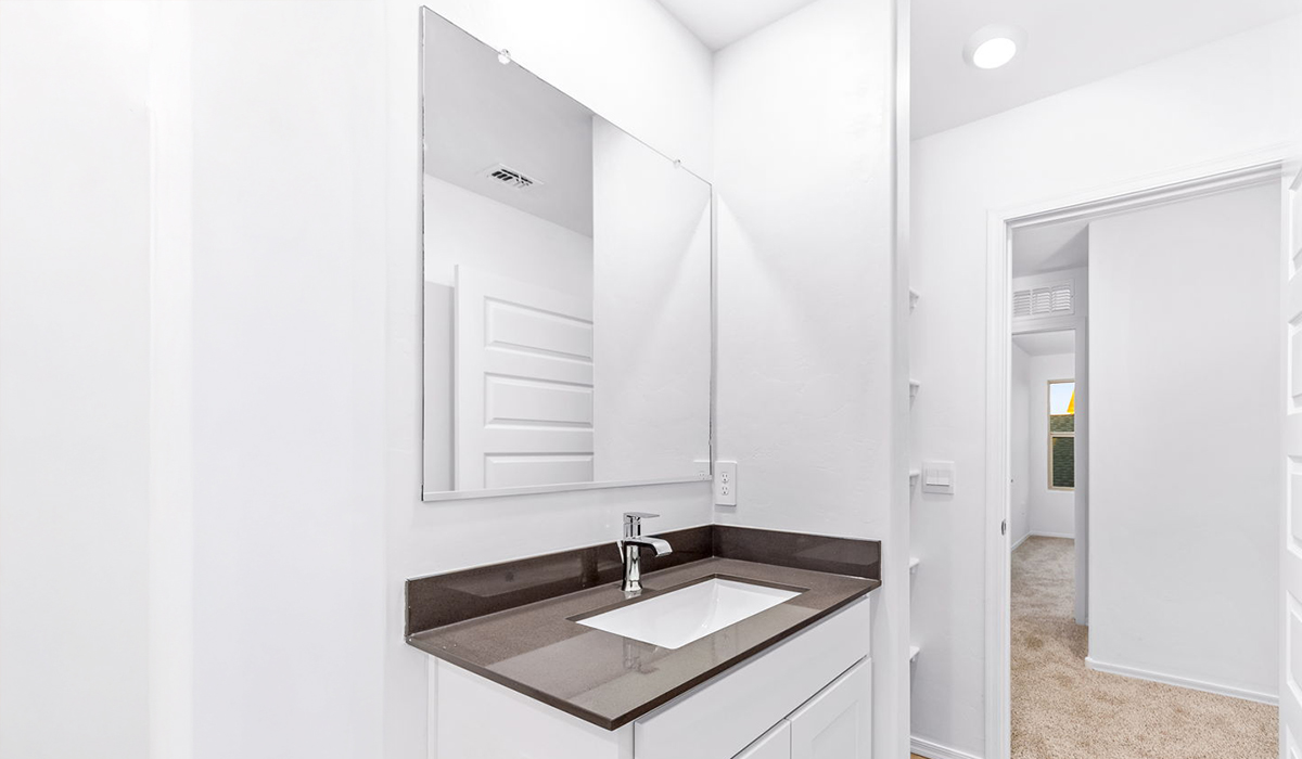 Welcome to The Madison at Blackhawk in Tucson, Arizona – the largest home in the community, offering an expansive 2,522 sq. ft. of living space designed for families seeking both luxury and functionality.  As you step through the inviting front porch, you're greeted by a thoughtfully designed entryway that leads into the heart of the home. The main level features a spacious great room that flows effortlessly into the dining area and the kitchen, making it an ideal space for entertaining and family gatherings. The kitchen is equipped with elegant granite countertops, a large island with a breakfast bar, modern appliances, and a pantry that provides ample storage, ensuring that the kitchen is as functional as it is stylish.  The main floor also includes a bedroom with easy access to a full bathroom, making it a perfect guest suite or a private home office. The convenient bathroom and direct access to the two-car garage enhance the home’s functionality, while the nearby utility room adds a layer of practicality to daily living.  Heading upstairs, you’ll find the family’s private quarters. The master suite is a true retreat, featuring a generously sized bedroom, a large walk-in closet, and an en-suite bathroom complete with dual vanities and a walk-in shower. The upper level also includes three additional bedrooms, a full bathroom, and a versatile loft area that can be tailored to fit your lifestyle, whether as a playroom, home office, or additional living space.  Back downstairs, step outside from the great room to the covered patio, where you can enjoy Tucson’s stunning weather year-round. Whether you’re hosting an outdoor gathering or simply relaxing after a long day, this space extends your living area and enhances the home’s inviting ambiance.  Designed with energy efficiency in mind, The Madison at Blackhawk is a DOE Zero Energy Ready Home, ensuring sustainability, comfort, and long-term savings.