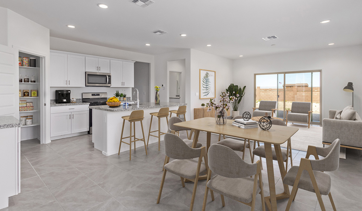 Welcome to The Madison at Blackhawk in Tucson, Arizona – the largest home in the community, offering an expansive 2,522 sq. ft. of living space designed for families seeking both luxury and functionality.  As you step through the inviting front porch, you're greeted by a thoughtfully designed entryway that leads into the heart of the home. The main level features a spacious great room that flows effortlessly into the dining area and the kitchen, making it an ideal space for entertaining and family gatherings. The kitchen is equipped with elegant granite countertops, a large island with a breakfast bar, modern appliances, and a pantry that provides ample storage, ensuring that the kitchen is as functional as it is stylish.  The main floor also includes a bedroom with easy access to a full bathroom, making it a perfect guest suite or a private home office. The convenient bathroom and direct access to the two-car garage enhance the home’s functionality, while the nearby utility room adds a layer of practicality to daily living.  Heading upstairs, you’ll find the family’s private quarters. The master suite is a true retreat, featuring a generously sized bedroom, a large walk-in closet, and an en-suite bathroom complete with dual vanities and a walk-in shower. The upper level also includes three additional bedrooms, a full bathroom, and a versatile loft area that can be tailored to fit your lifestyle, whether as a playroom, home office, or additional living space.  Back downstairs, step outside from the great room to the covered patio, where you can enjoy Tucson’s stunning weather year-round. Whether you’re hosting an outdoor gathering or simply relaxing after a long day, this space extends your living area and enhances the home’s inviting ambiance.  Designed with energy efficiency in mind, The Madison at Blackhawk is a DOE Zero Energy Ready Home, ensuring sustainability, comfort, and long-term savings.