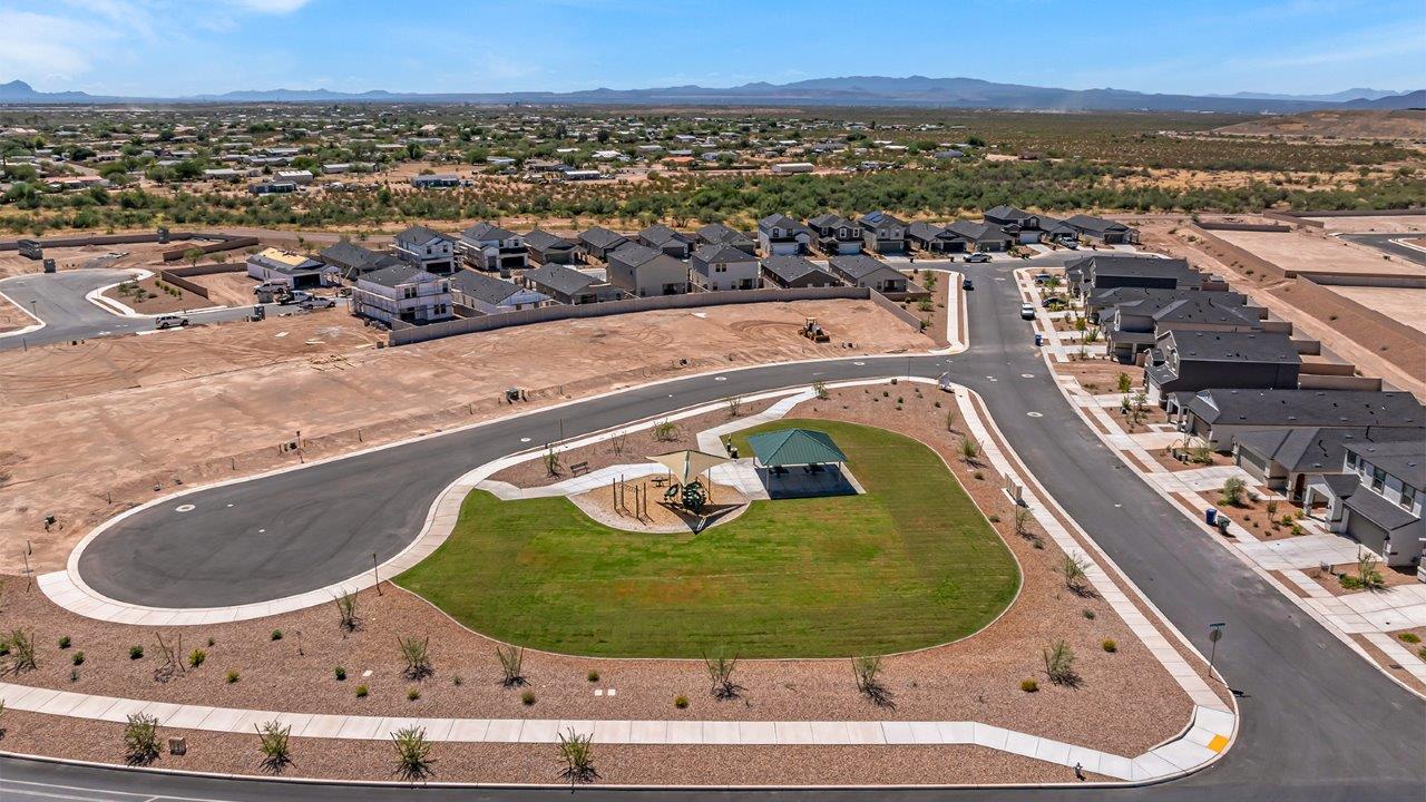 Welcome to The Madison at Blackhawk in Tucson, Arizona – the largest home in the community, offering an expansive 2,522 sq. ft. of living space designed for families seeking both luxury and functionality.  As you step through the inviting front porch, you're greeted by a thoughtfully designed entryway that leads into the heart of the home. The main level features a spacious great room that flows effortlessly into the dining area and the kitchen, making it an ideal space for entertaining and family gatherings. The kitchen is equipped with elegant granite countertops, a large island with a breakfast bar, modern appliances, and a pantry that provides ample storage, ensuring that the kitchen is as functional as it is stylish.  The main floor also includes a bedroom with easy access to a full bathroom, making it a perfect guest suite or a private home office. The convenient bathroom and direct access to the two-car garage enhance the home’s functionality, while the nearby utility room adds a layer of practicality to daily living.  Heading upstairs, you’ll find the family’s private quarters. The master suite is a true retreat, featuring a generously sized bedroom, a large walk-in closet, and an en-suite bathroom complete with dual vanities and a walk-in shower. The upper level also includes three additional bedrooms, a full bathroom, and a versatile loft area that can be tailored to fit your lifestyle, whether as a playroom, home office, or additional living space.  Back downstairs, step outside from the great room to the covered patio, where you can enjoy Tucson’s stunning weather year-round. Whether you’re hosting an outdoor gathering or simply relaxing after a long day, this space extends your living area and enhances the home’s inviting ambiance.  Designed with energy efficiency in mind, The Madison at Blackhawk is a DOE Zero Energy Ready Home, ensuring sustainability, comfort, and long-term savings.