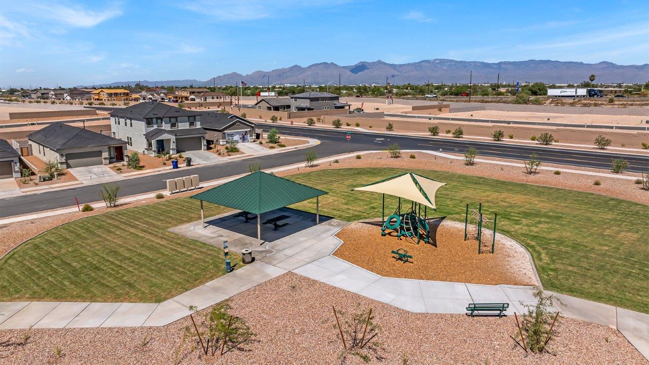 Welcome to The Madison at Blackhawk in Tucson, Arizona – the largest home in the community, offering an expansive 2,522 sq. ft. of living space designed for families seeking both luxury and functionality.  As you step through the inviting front porch, you're greeted by a thoughtfully designed entryway that leads into the heart of the home. The main level features a spacious great room that flows effortlessly into the dining area and the kitchen, making it an ideal space for entertaining and family gatherings. The kitchen is equipped with elegant granite countertops, a large island with a breakfast bar, modern appliances, and a pantry that provides ample storage, ensuring that the kitchen is as functional as it is stylish.  The main floor also includes a bedroom with easy access to a full bathroom, making it a perfect guest suite or a private home office. The convenient bathroom and direct access to the two-car garage enhance the home’s functionality, while the nearby utility room adds a layer of practicality to daily living.  Heading upstairs, you’ll find the family’s private quarters. The master suite is a true retreat, featuring a generously sized bedroom, a large walk-in closet, and an en-suite bathroom complete with dual vanities and a walk-in shower. The upper level also includes three additional bedrooms, a full bathroom, and a versatile loft area that can be tailored to fit your lifestyle, whether as a playroom, home office, or additional living space.  Back downstairs, step outside from the great room to the covered patio, where you can enjoy Tucson’s stunning weather year-round. Whether you’re hosting an outdoor gathering or simply relaxing after a long day, this space extends your living area and enhances the home’s inviting ambiance.  Designed with energy efficiency in mind, The Madison at Blackhawk is a DOE Zero Energy Ready Home, ensuring sustainability, comfort, and long-term savings.