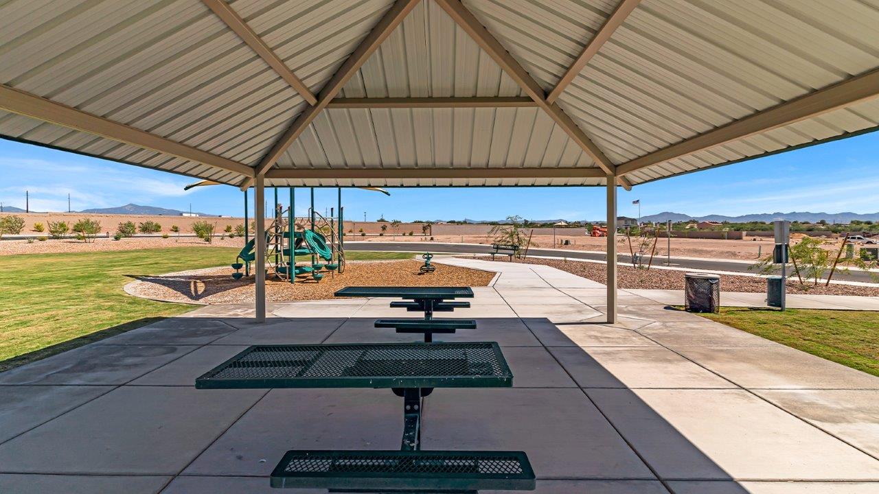 Welcome to The Madison at Blackhawk in Tucson, Arizona – the largest home in the community, offering an expansive 2,522 sq. ft. of living space designed for families seeking both luxury and functionality.  As you step through the inviting front porch, you're greeted by a thoughtfully designed entryway that leads into the heart of the home. The main level features a spacious great room that flows effortlessly into the dining area and the kitchen, making it an ideal space for entertaining and family gatherings. The kitchen is equipped with elegant granite countertops, a large island with a breakfast bar, modern appliances, and a pantry that provides ample storage, ensuring that the kitchen is as functional as it is stylish.  The main floor also includes a bedroom with easy access to a full bathroom, making it a perfect guest suite or a private home office. The convenient bathroom and direct access to the two-car garage enhance the home’s functionality, while the nearby utility room adds a layer of practicality to daily living.  Heading upstairs, you’ll find the family’s private quarters. The master suite is a true retreat, featuring a generously sized bedroom, a large walk-in closet, and an en-suite bathroom complete with dual vanities and a walk-in shower. The upper level also includes three additional bedrooms, a full bathroom, and a versatile loft area that can be tailored to fit your lifestyle, whether as a playroom, home office, or additional living space.  Back downstairs, step outside from the great room to the covered patio, where you can enjoy Tucson’s stunning weather year-round. Whether you’re hosting an outdoor gathering or simply relaxing after a long day, this space extends your living area and enhances the home’s inviting ambiance.  Designed with energy efficiency in mind, The Madison at Blackhawk is a DOE Zero Energy Ready Home, ensuring sustainability, comfort, and long-term savings.