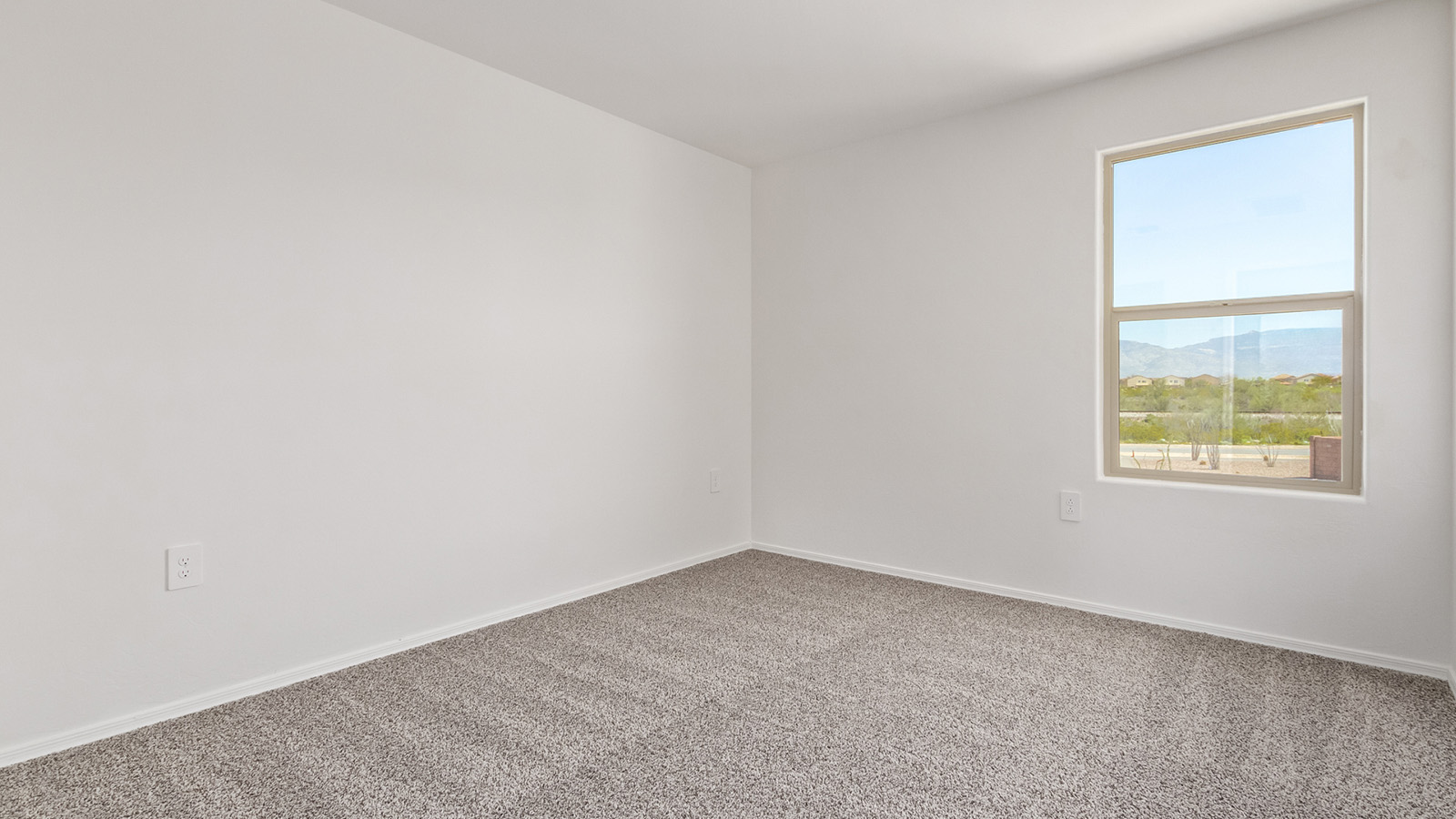 Welcome to The Madison at Blackhawk in Tucson, Arizona – the largest home in the community, offering an expansive 2,522 sq. ft. of living space designed for families seeking both luxury and functionality.  As you step through the inviting front porch, you're greeted by a thoughtfully designed entryway that leads into the heart of the home. The main level features a spacious great room that flows effortlessly into the dining area and the kitchen, making it an ideal space for entertaining and family gatherings. The kitchen is equipped with elegant granite countertops, a large island with a breakfast bar, modern appliances, and a pantry that provides ample storage, ensuring that the kitchen is as functional as it is stylish.  The main floor also includes a bedroom with easy access to a full bathroom, making it a perfect guest suite or a private home office. The convenient bathroom and direct access to the two-car garage enhance the home’s functionality, while the nearby utility room adds a layer of practicality to daily living.  Heading upstairs, you’ll find the family’s private quarters. The master suite is a true retreat, featuring a generously sized bedroom, a large walk-in closet, and an en-suite bathroom complete with dual vanities and a walk-in shower. The upper level also includes three additional bedrooms, a full bathroom, and a versatile loft area that can be tailored to fit your lifestyle, whether as a playroom, home office, or additional living space.  Back downstairs, step outside from the great room to the covered patio, where you can enjoy Tucson’s stunning weather year-round. Whether you’re hosting an outdoor gathering or simply relaxing after a long day, this space extends your living area and enhances the home’s inviting ambiance.  Designed with energy efficiency in mind, The Madison at Blackhawk is a DOE Zero Energy Ready Home, ensuring sustainability, comfort, and long-term savings.