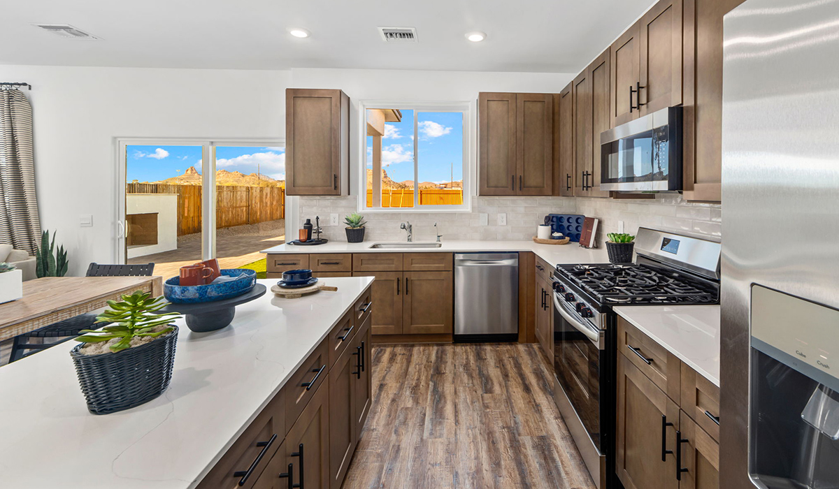 Discover the Gila — a versatile two-story floor plan offering 2,057 sq. ft. of comfortable, modern living in our new Redford Estate community of Southwest Tucson, Arizona.  Thoughtfully crafted for households of all sizes, the Gila features four bedrooms, a spacious loft, and three full bathrooms, ensuring every family member has their own space to unwind and recharge.  A standout highlight of this home is the guest-style suite on the main floor, offering convenient access to a full bathroom. Perfect for visitors, multigenerational living, or private home office, this main-level bedroom offers exceptional flexibility.  The main floor creates an inviting flow, with a generous great room that connects seamlessly to the dining area and kitchen. The kitchen features a large center island, Shaker-style cabinetry, and ample storage space to include a large pantry.  Upstairs, the Gila continues to impress with thoughtful design and family-friendly layout. The well-appointed primary bedroom includes a private en-suite bathroom and large walk-in closet. Bedrooms 2 and 3, along with the loft, share a full bathroom conveniently located for easy access. An additional standout feature is Bedroom 2, which includes a large walk-in closet—a perfect setup for teens, young adults, or anyone who appreciates extra storage and personal space. The second floor also features a large laundry room, conveniently located near the bedrooms.  Our homes at Redford Estates are designed with the future in mind. Each home features a Spanish lace stucco exterior, landscaped front yards with auto drip irrigation, and large backyards that are fully fenced and ready for your personal touch. Inside, the Home is Connected® Smart Home package brings modern convenience to your fingertips with a smart thermostat, video doorbell, keyless entry, and a Wi-Fi-enabled garage door opener.  With three full bathrooms, smartly arranged bedrooms, and spaces crafted for comfort and flexibility, the Gila is designed to meet the needs of today's busy and evolving lifestyles.