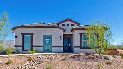 Welcome to The Oasis at Rocking K, a premier D.R. Horton new home community nestled in the picturesque landscapes of Vail, Arizona, where new homes blend seamlessly with the breathtaking surroundings of the Rincon Mountains. Experience the perfect balance of tranquility and modern convenience in this master-planned neighborhood, designed to offer a lifestyle that caters to families, nature enthusiasts, and anyone seeking a peaceful yet connected community. The Oasis at Rocking K features five beautifully designed one-story floor plans ranging from 1,400 to 1,900 square feet, each crafted with the high-quality features and finishes D.R. Horton is known for. Homes in Rocking K feature a Spanish lace stucco exterior, tile roofs, and meticulously landscaped front yards with auto drip irrigation. Inside, you’ll find luxurious quartz countertops in the kitchens and bathrooms, 42” shaker-style cabinets with modern cabinet pulls, and wood-look tile flooring throughout the main living areas. Homes also include covered front porches and back patios, perfect for enjoying Arizona’s stunning sunsets and clear night skies. Each home in The Oasis at Rocking K is equipped with D.R. Horton’s Home is Connected® Smart Home package, which includes a smart thermostat, video doorbell, keyless entry, Wi-Fi-enabled garage door opener, and Deako light switches. Additionally, these homes meet the stringent DOE Zero Energy Ready Home standards, making them not only comfortable and modern but also exceptionally energy-efficient. With features like spray foam insulation, tankless water heaters and LED lighting, these homes are designed to reduce your environmental footprint and provide long-term savings on energy costs. Living at Rocking K means being part of a vibrant, family-oriented community with a strong sense of connection among residents. The Oasis at Rocking K offers a variety of amenities, including ramadas, picnic tables, and grassy areas perfect for gatherings. Residents also have access to the greater Rocking K master-planned neighborhood amenities, such as a splashpad, large event lawn, walking paths, multipurpose fields, basketball and pickleball courts, and an innovative playground with a zip-line and jungle gym. The new K-8 school, set to open in 2025, is just one of the many features that make Rocking K ideal for families. Life at Rocking K is further enriched by a lively calendar of lifestyle events, thoughtfully organized by the Rocking K Homeowners Association. These events are a cornerstone of community life, fostering a strong sense of connection among residents. Whether you’re looking to enjoy a quiet evening star gazing in the park or engage in fun activities with neighbors, there’s always something happening. The quarterly lifestyle calendar is packed with regular and seasonal events, including movie nights in the park, sports and summer camps for kids, and wine tasting events for adults. Families can join hiking groups, participate in trivia nights, or enjoy the various holiday celebrations. The community comes alive during the holidays with loads of themed events, arts and crafts fairs, and car shows. Rocking K’s commitment to providing a dynamic and engaging environment ensures that there’s always an opportunity to make memories and build lasting friendships right in your neighborhood. Residents of Rocking K benefit from easy access to I-10, making commutes to Tucson and surrounding areas a breeze. The community is close to major employers such as Davis-Monthan Air Force Base, Raytheon, and the University of Arizona, as well as top-notch healthcare facilities like TMC Rincon and Northwest Hospital East. The nearby Houghton Town Center and Houghton Rd. business corridor offer convenient shopping, dining, and services. For outdoor enthusiasts, Rocking K is surrounded by natural beauty and recreational opportunities. Explore the hiking and biking trails at Colossal Cave Mountain Park, Saguaro National Park East, and the Arizona Trail. Enjoy golfing at Del Lago Golf Course, or take a short drive to Sonoita for a day trip to Arizona’s Wine Country. Whether it’s hiking, camping, or simply taking in the stunning views, Rocking K is your gateway to the great outdoors. With 360-degree mountain views, calm and quiet evenings, and a location that’s close to everything you need, Rocking K is truly a community where you can thrive. Experience the best of Arizona living at The Oasis at Rocking K, where your new home awaits in a community that offers everything you need for a fulfilling lifestyle.