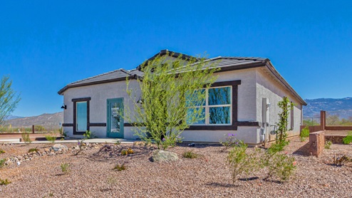Welcome to The Oasis at Rocking K, a premier D.R. Horton new home community nestled in the picturesque landscapes of Vail, Arizona, where new homes blend seamlessly with the breathtaking surroundings of the Rincon Mountains. Experience the perfect balance of tranquility and modern convenience in this master-planned neighborhood, designed to offer a lifestyle that caters to families, nature enthusiasts, and anyone seeking a peaceful yet connected community. The Oasis at Rocking K features five beautifully designed one-story floor plans ranging from 1,400 to 1,900 square feet, each crafted with the high-quality features and finishes D.R. Horton is known for. Homes in Rocking K feature a Spanish lace stucco exterior, tile roofs, and meticulously landscaped front yards with auto drip irrigation. Inside, you’ll find luxurious quartz countertops in the kitchens and bathrooms, 42” shaker-style cabinets with modern cabinet pulls, and wood-look tile flooring throughout the main living areas. Homes also include covered front porches and back patios, perfect for enjoying Arizona’s stunning sunsets and clear night skies. Each home in The Oasis at Rocking K is equipped with D.R. Horton’s Home is Connected® Smart Home package, which includes a smart thermostat, video doorbell, keyless entry, Wi-Fi-enabled garage door opener, and Deako light switches. Additionally, these homes meet the stringent DOE Zero Energy Ready Home standards, making them not only comfortable and modern but also exceptionally energy-efficient. With features like spray foam insulation, tankless water heaters and LED lighting, these homes are designed to reduce your environmental footprint and provide long-term savings on energy costs. Living at Rocking K means being part of a vibrant, family-oriented community with a strong sense of connection among residents. The Oasis at Rocking K offers a variety of amenities, including ramadas, picnic tables, and grassy areas perfect for gatherings. Residents also have access to the greater Rocking K master-planned neighborhood amenities, such as a splashpad, large event lawn, walking paths, multipurpose fields, basketball and pickleball courts, and an innovative playground with a zip-line and jungle gym. The new K-8 school, set to open in 2025, is just one of the many features that make Rocking K ideal for families. Life at Rocking K is further enriched by a lively calendar of lifestyle events, thoughtfully organized by the Rocking K Homeowners Association. These events are a cornerstone of community life, fostering a strong sense of connection among residents. Whether you’re looking to enjoy a quiet evening star gazing in the park or engage in fun activities with neighbors, there’s always something happening. The quarterly lifestyle calendar is packed with regular and seasonal events, including movie nights in the park, sports and summer camps for kids, and wine tasting events for adults. Families can join hiking groups, participate in trivia nights, or enjoy the various holiday celebrations. The community comes alive during the holidays with loads of themed events, arts and crafts fairs, and car shows. Rocking K’s commitment to providing a dynamic and engaging environment ensures that there’s always an opportunity to make memories and build lasting friendships right in your neighborhood. Residents of Rocking K benefit from easy access to I-10, making commutes to Tucson and surrounding areas a breeze. The community is close to major employers such as Davis-Monthan Air Force Base, Raytheon, and the University of Arizona, as well as top-notch healthcare facilities like TMC Rincon and Northwest Hospital East. The nearby Houghton Town Center and Houghton Rd. business corridor offer convenient shopping, dining, and services. For outdoor enthusiasts, Rocking K is surrounded by natural beauty and recreational opportunities. Explore the hiking and biking trails at Colossal Cave Mountain Park, Saguaro National Park East, and the Arizona Trail. Enjoy golfing at Del Lago Golf Course, or take a short drive to Sonoita for a day trip to Arizona’s Wine Country. Whether it’s hiking, camping, or simply taking in the stunning views, Rocking K is your gateway to the great outdoors. With 360-degree mountain views, calm and quiet evenings, and a location that’s close to everything you need, Rocking K is truly a community where you can thrive. Experience the best of Arizona living at The Oasis at Rocking K, where your new home awaits in a community that offers everything you need for a fulfilling lifestyle.