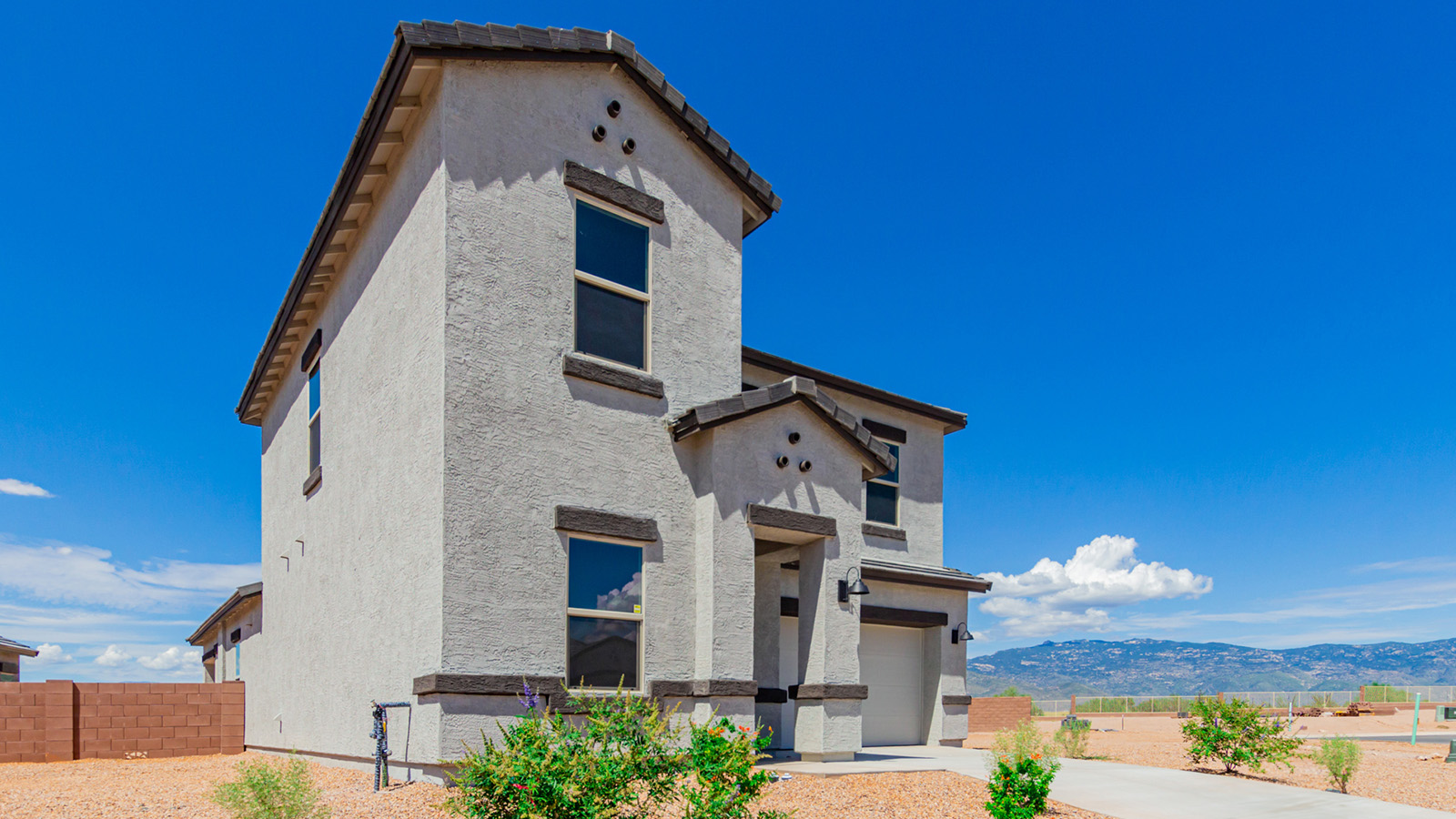 Introducing The River plan at The Oasis at Rocking K, a standout two-story new home that epitomizes spacious living and modern amenities in the scenic backdrop of Vail, Arizona. Nestled within this master-planned community, The River offers an impressive 2,396 square feet of living space, making it the largest floorplan available at The Oasis. This home is intentionally designed to accommodate the needs of growing families, with five bedrooms and three bathrooms, ensuring plenty of space for everyone.  The exterior of The River plan exudes charm and character, with its Spanish lace stucco finish and tile roof that blends seamlessly into the picturesque surroundings. The home’s front yard is meticulously landscaped with auto drip irrigation, providing a welcoming entrance to this beautiful residence.  Upon entering The River, you'll be greeted by a bright and inviting great room that flows effortlessly into the dining room and kitchen, creating a harmonious space perfect for entertaining or family gatherings. The kitchen is a chef’s day dream, featuring quartz countertops, 42” shaker-style cabinets, and stainless steel appliances, all designed to inspire culinary creativity. The main floor also includes the luxurious owner’s suite, which serves as a private sanctuary. This suite features a spacious walk-in closet and an en-suite bathroom with dual vanities, a walk-in shower, and a soaking tub, providing the perfect retreat at the end of the day. Additionally, a second bedroom on the main floor offers flexibility, ideal for guests or a home office.  As you ascend to the second story, you'll find three additional bedrooms, all with easy access to a full bathroom. A generous loft area on the second floor offers additional living space, ideal for a media room, play area, or home gym.  The River plan is not just about style and space; it’s also about modern convenience and energy efficiency. The home is equipped with D.R. Horton’s Home is Connected® Smart Home package, which includes a smart thermostat, video doorbell, keyless entry, Wi-Fi-enabled garage door opener, and Deako light switches, ensuring that your home is as functional as it is beautiful. Additionally, the home meets the DOE Zero Energy Ready Home standards, featuring energy-efficient elements such as spray foam insulation, a tankless water heater, LED lighting throughout and more.  Living at The Oasis at Rocking K means more than just owning a home; it means being part of a vibrant community. With access to amenities like ramadas, picnic areas, walking paths, and recreational fields, plus the greater Rocking K master-planned neighborhood’s splashpad, event lawn, playground, and events, there’s always something to do. Residents also enjoy the convenience of nearby schools, shopping, dining, and outdoor recreational opportunities, making The Oasis at Rocking K the perfect place to call home.  The River plan at The Oasis at Rocking K is where space, style, and smart living converge, offering a home designed for the way you live today.