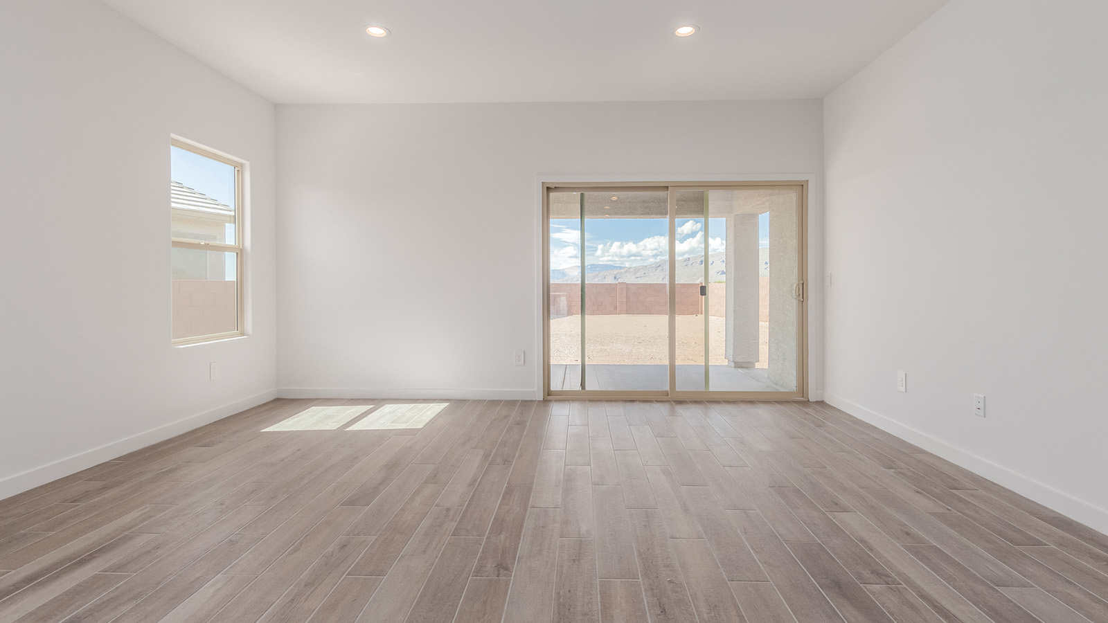 Introducing The River plan at The Oasis at Rocking K, a standout two-story new home that epitomizes spacious living and modern amenities in the scenic backdrop of Vail, Arizona. Nestled within this master-planned community, The River offers an impressive 2,396 square feet of living space, making it the largest floorplan available at The Oasis. This home is intentionally designed to accommodate the needs of growing families, with five bedrooms and three bathrooms, ensuring plenty of space for everyone.  The exterior of The River plan exudes charm and character, with its Spanish lace stucco finish and tile roof that blends seamlessly into the picturesque surroundings. The home’s front yard is meticulously landscaped with auto drip irrigation, providing a welcoming entrance to this beautiful residence.  Upon entering The River, you'll be greeted by a bright and inviting great room that flows effortlessly into the dining room and kitchen, creating a harmonious space perfect for entertaining or family gatherings. The kitchen is a chef’s day dream, featuring quartz countertops, 42” shaker-style cabinets, and stainless steel appliances, all designed to inspire culinary creativity. The main floor also includes the luxurious owner’s suite, which serves as a private sanctuary. This suite features a spacious walk-in closet and an en-suite bathroom with dual vanities, a walk-in shower, and a soaking tub, providing the perfect retreat at the end of the day. Additionally, a second bedroom on the main floor offers flexibility, ideal for guests or a home office.  As you ascend to the second story, you'll find three additional bedrooms, all with easy access to a full bathroom. A generous loft area on the second floor offers additional living space, ideal for a media room, play area, or home gym.  The River plan is not just about style and space; it’s also about modern convenience and energy efficiency. The home is equipped with D.R. Horton’s Home is Connected® Smart Home package, which includes a smart thermostat, video doorbell, keyless entry, Wi-Fi-enabled garage door opener, and Deako light switches, ensuring that your home is as functional as it is beautiful. Additionally, the home meets the DOE Zero Energy Ready Home standards, featuring energy-efficient elements such as spray foam insulation, a tankless water heater, LED lighting throughout and more.  Living at The Oasis at Rocking K means more than just owning a home; it means being part of a vibrant community. With access to amenities like ramadas, picnic areas, walking paths, and recreational fields, plus the greater Rocking K master-planned neighborhood’s splashpad, event lawn, playground, and events, there’s always something to do. Residents also enjoy the convenience of nearby schools, shopping, dining, and outdoor recreational opportunities, making The Oasis at Rocking K the perfect place to call home.  The River plan at The Oasis at Rocking K is where space, style, and smart living converge, offering a home designed for the way you live today.