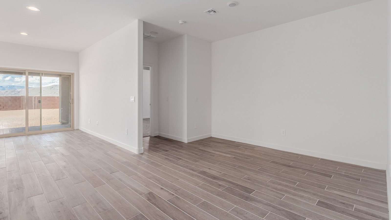 Introducing The River plan at The Oasis at Rocking K, a standout two-story new home that epitomizes spacious living and modern amenities in the scenic backdrop of Vail, Arizona. Nestled within this master-planned community, The River offers an impressive 2,396 square feet of living space, making it the largest floorplan available at The Oasis. This home is intentionally designed to accommodate the needs of growing families, with five bedrooms and three bathrooms, ensuring plenty of space for everyone.  The exterior of The River plan exudes charm and character, with its Spanish lace stucco finish and tile roof that blends seamlessly into the picturesque surroundings. The home’s front yard is meticulously landscaped with auto drip irrigation, providing a welcoming entrance to this beautiful residence.  Upon entering The River, you'll be greeted by a bright and inviting great room that flows effortlessly into the dining room and kitchen, creating a harmonious space perfect for entertaining or family gatherings. The kitchen is a chef’s day dream, featuring quartz countertops, 42” shaker-style cabinets, and stainless steel appliances, all designed to inspire culinary creativity. The main floor also includes the luxurious owner’s suite, which serves as a private sanctuary. This suite features a spacious walk-in closet and an en-suite bathroom with dual vanities, a walk-in shower, and a soaking tub, providing the perfect retreat at the end of the day. Additionally, a second bedroom on the main floor offers flexibility, ideal for guests or a home office.  As you ascend to the second story, you'll find three additional bedrooms, all with easy access to a full bathroom. A generous loft area on the second floor offers additional living space, ideal for a media room, play area, or home gym.  The River plan is not just about style and space; it’s also about modern convenience and energy efficiency. The home is equipped with D.R. Horton’s Home is Connected® Smart Home package, which includes a smart thermostat, video doorbell, keyless entry, Wi-Fi-enabled garage door opener, and Deako light switches, ensuring that your home is as functional as it is beautiful. Additionally, the home meets the DOE Zero Energy Ready Home standards, featuring energy-efficient elements such as spray foam insulation, a tankless water heater, LED lighting throughout and more.  Living at The Oasis at Rocking K means more than just owning a home; it means being part of a vibrant community. With access to amenities like ramadas, picnic areas, walking paths, and recreational fields, plus the greater Rocking K master-planned neighborhood’s splashpad, event lawn, playground, and events, there’s always something to do. Residents also enjoy the convenience of nearby schools, shopping, dining, and outdoor recreational opportunities, making The Oasis at Rocking K the perfect place to call home.  The River plan at The Oasis at Rocking K is where space, style, and smart living converge, offering a home designed for the way you live today.