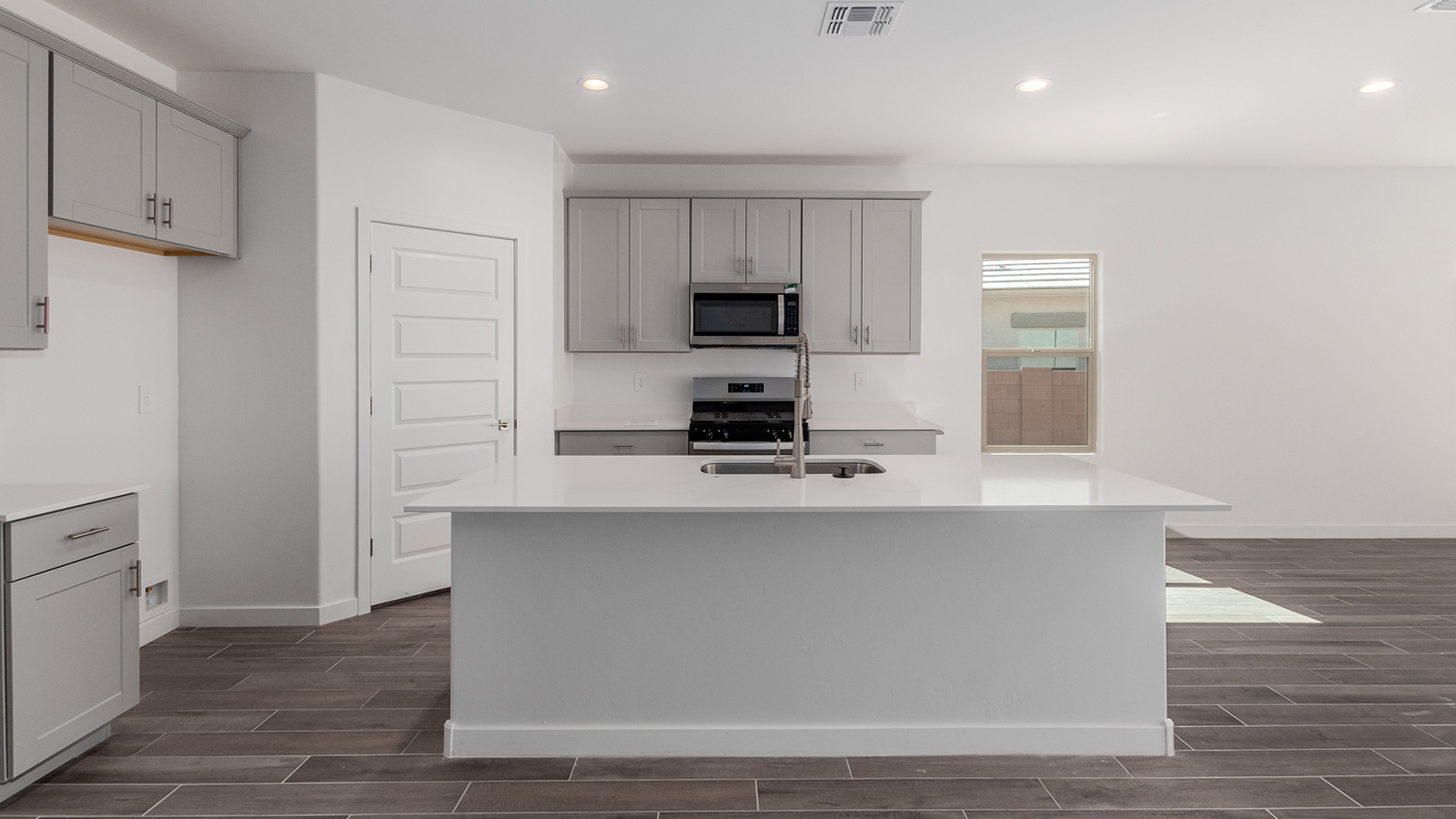 Introducing The River plan at The Oasis at Rocking K, a standout two-story new home that epitomizes spacious living and modern amenities in the scenic backdrop of Vail, Arizona. Nestled within this master-planned community, The River offers an impressive 2,396 square feet of living space, making it the largest floorplan available at The Oasis. This home is intentionally designed to accommodate the needs of growing families, with five bedrooms and three bathrooms, ensuring plenty of space for everyone.  The exterior of The River plan exudes charm and character, with its Spanish lace stucco finish and tile roof that blends seamlessly into the picturesque surroundings. The home’s front yard is meticulously landscaped with auto drip irrigation, providing a welcoming entrance to this beautiful residence.  Upon entering The River, you'll be greeted by a bright and inviting great room that flows effortlessly into the dining room and kitchen, creating a harmonious space perfect for entertaining or family gatherings. The kitchen is a chef’s day dream, featuring quartz countertops, 42” shaker-style cabinets, and stainless steel appliances, all designed to inspire culinary creativity. The main floor also includes the luxurious owner’s suite, which serves as a private sanctuary. This suite features a spacious walk-in closet and an en-suite bathroom with dual vanities, a walk-in shower, and a soaking tub, providing the perfect retreat at the end of the day. Additionally, a second bedroom on the main floor offers flexibility, ideal for guests or a home office.  As you ascend to the second story, you'll find three additional bedrooms, all with easy access to a full bathroom. A generous loft area on the second floor offers additional living space, ideal for a media room, play area, or home gym.  The River plan is not just about style and space; it’s also about modern convenience and energy efficiency. The home is equipped with D.R. Horton’s Home is Connected® Smart Home package, which includes a smart thermostat, video doorbell, keyless entry, Wi-Fi-enabled garage door opener, and Deako light switches, ensuring that your home is as functional as it is beautiful. Additionally, the home meets the DOE Zero Energy Ready Home standards, featuring energy-efficient elements such as spray foam insulation, a tankless water heater, LED lighting throughout and more.  Living at The Oasis at Rocking K means more than just owning a home; it means being part of a vibrant community. With access to amenities like ramadas, picnic areas, walking paths, and recreational fields, plus the greater Rocking K master-planned neighborhood’s splashpad, event lawn, playground, and events, there’s always something to do. Residents also enjoy the convenience of nearby schools, shopping, dining, and outdoor recreational opportunities, making The Oasis at Rocking K the perfect place to call home.  The River plan at The Oasis at Rocking K is where space, style, and smart living converge, offering a home designed for the way you live today.