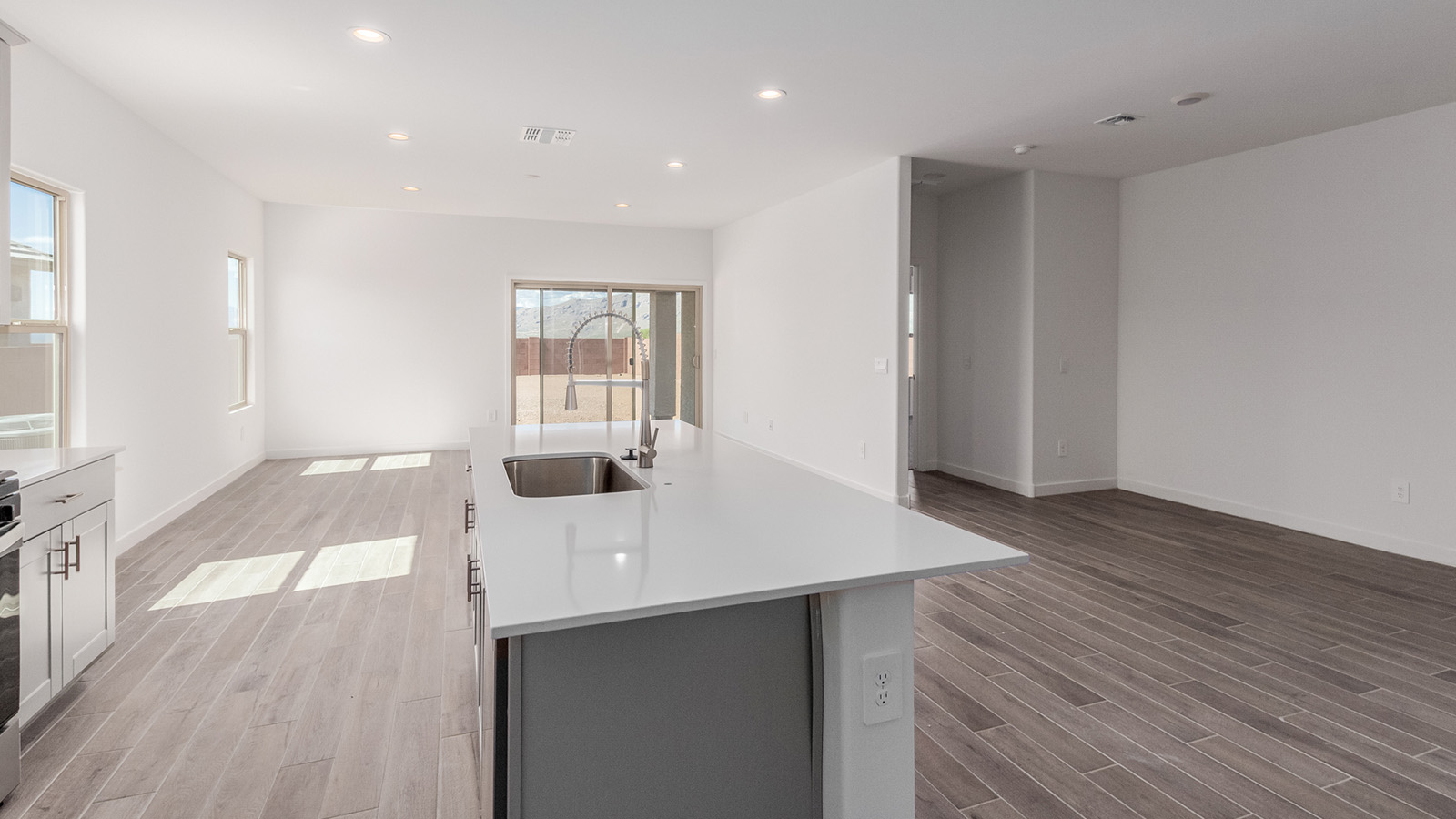 Introducing The River plan at The Oasis at Rocking K, a standout two-story new home that epitomizes spacious living and modern amenities in the scenic backdrop of Vail, Arizona. Nestled within this master-planned community, The River offers an impressive 2,396 square feet of living space, making it the largest floorplan available at The Oasis. This home is intentionally designed to accommodate the needs of growing families, with five bedrooms and three bathrooms, ensuring plenty of space for everyone.  The exterior of The River plan exudes charm and character, with its Spanish lace stucco finish and tile roof that blends seamlessly into the picturesque surroundings. The home’s front yard is meticulously landscaped with auto drip irrigation, providing a welcoming entrance to this beautiful residence.  Upon entering The River, you'll be greeted by a bright and inviting great room that flows effortlessly into the dining room and kitchen, creating a harmonious space perfect for entertaining or family gatherings. The kitchen is a chef’s day dream, featuring quartz countertops, 42” shaker-style cabinets, and stainless steel appliances, all designed to inspire culinary creativity. The main floor also includes the luxurious owner’s suite, which serves as a private sanctuary. This suite features a spacious walk-in closet and an en-suite bathroom with dual vanities, a walk-in shower, and a soaking tub, providing the perfect retreat at the end of the day. Additionally, a second bedroom on the main floor offers flexibility, ideal for guests or a home office.  As you ascend to the second story, you'll find three additional bedrooms, all with easy access to a full bathroom. A generous loft area on the second floor offers additional living space, ideal for a media room, play area, or home gym.  The River plan is not just about style and space; it’s also about modern convenience and energy efficiency. The home is equipped with D.R. Horton’s Home is Connected® Smart Home package, which includes a smart thermostat, video doorbell, keyless entry, Wi-Fi-enabled garage door opener, and Deako light switches, ensuring that your home is as functional as it is beautiful. Additionally, the home meets the DOE Zero Energy Ready Home standards, featuring energy-efficient elements such as spray foam insulation, a tankless water heater, LED lighting throughout and more.  Living at The Oasis at Rocking K means more than just owning a home; it means being part of a vibrant community. With access to amenities like ramadas, picnic areas, walking paths, and recreational fields, plus the greater Rocking K master-planned neighborhood’s splashpad, event lawn, playground, and events, there’s always something to do. Residents also enjoy the convenience of nearby schools, shopping, dining, and outdoor recreational opportunities, making The Oasis at Rocking K the perfect place to call home.  The River plan at The Oasis at Rocking K is where space, style, and smart living converge, offering a home designed for the way you live today.