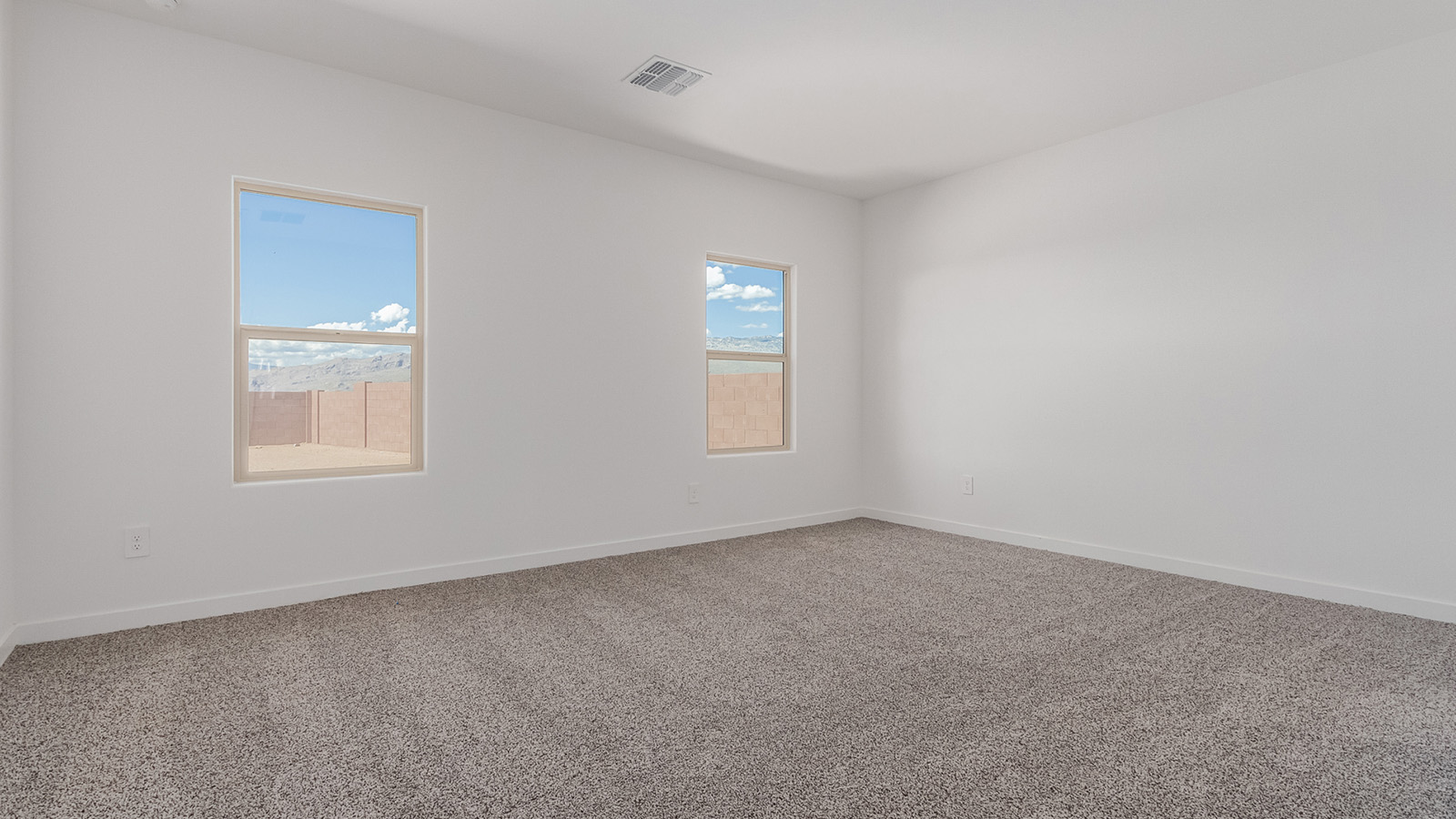 Introducing The River plan at The Oasis at Rocking K, a standout two-story new home that epitomizes spacious living and modern amenities in the scenic backdrop of Vail, Arizona. Nestled within this master-planned community, The River offers an impressive 2,396 square feet of living space, making it the largest floorplan available at The Oasis. This home is intentionally designed to accommodate the needs of growing families, with five bedrooms and three bathrooms, ensuring plenty of space for everyone.  The exterior of The River plan exudes charm and character, with its Spanish lace stucco finish and tile roof that blends seamlessly into the picturesque surroundings. The home’s front yard is meticulously landscaped with auto drip irrigation, providing a welcoming entrance to this beautiful residence.  Upon entering The River, you'll be greeted by a bright and inviting great room that flows effortlessly into the dining room and kitchen, creating a harmonious space perfect for entertaining or family gatherings. The kitchen is a chef’s day dream, featuring quartz countertops, 42” shaker-style cabinets, and stainless steel appliances, all designed to inspire culinary creativity. The main floor also includes the luxurious owner’s suite, which serves as a private sanctuary. This suite features a spacious walk-in closet and an en-suite bathroom with dual vanities, a walk-in shower, and a soaking tub, providing the perfect retreat at the end of the day. Additionally, a second bedroom on the main floor offers flexibility, ideal for guests or a home office.  As you ascend to the second story, you'll find three additional bedrooms, all with easy access to a full bathroom. A generous loft area on the second floor offers additional living space, ideal for a media room, play area, or home gym.  The River plan is not just about style and space; it’s also about modern convenience and energy efficiency. The home is equipped with D.R. Horton’s Home is Connected® Smart Home package, which includes a smart thermostat, video doorbell, keyless entry, Wi-Fi-enabled garage door opener, and Deako light switches, ensuring that your home is as functional as it is beautiful. Additionally, the home meets the DOE Zero Energy Ready Home standards, featuring energy-efficient elements such as spray foam insulation, a tankless water heater, LED lighting throughout and more.  Living at The Oasis at Rocking K means more than just owning a home; it means being part of a vibrant community. With access to amenities like ramadas, picnic areas, walking paths, and recreational fields, plus the greater Rocking K master-planned neighborhood’s splashpad, event lawn, playground, and events, there’s always something to do. Residents also enjoy the convenience of nearby schools, shopping, dining, and outdoor recreational opportunities, making The Oasis at Rocking K the perfect place to call home.  The River plan at The Oasis at Rocking K is where space, style, and smart living converge, offering a home designed for the way you live today.