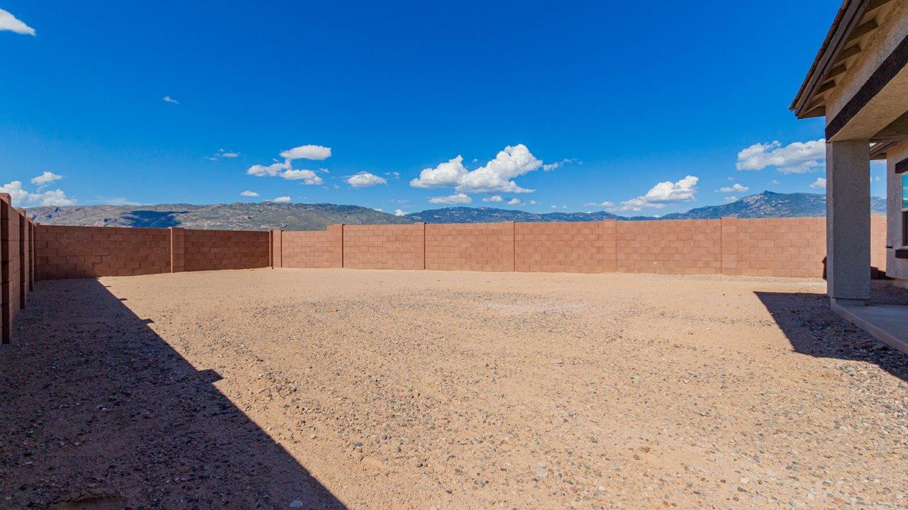 Introducing The River plan at The Oasis at Rocking K, a standout two-story new home that epitomizes spacious living and modern amenities in the scenic backdrop of Vail, Arizona. Nestled within this master-planned community, The River offers an impressive 2,396 square feet of living space, making it the largest floorplan available at The Oasis. This home is intentionally designed to accommodate the needs of growing families, with five bedrooms and three bathrooms, ensuring plenty of space for everyone.  The exterior of The River plan exudes charm and character, with its Spanish lace stucco finish and tile roof that blends seamlessly into the picturesque surroundings. The home’s front yard is meticulously landscaped with auto drip irrigation, providing a welcoming entrance to this beautiful residence.  Upon entering The River, you'll be greeted by a bright and inviting great room that flows effortlessly into the dining room and kitchen, creating a harmonious space perfect for entertaining or family gatherings. The kitchen is a chef’s day dream, featuring quartz countertops, 42” shaker-style cabinets, and stainless steel appliances, all designed to inspire culinary creativity. The main floor also includes the luxurious owner’s suite, which serves as a private sanctuary. This suite features a spacious walk-in closet and an en-suite bathroom with dual vanities, a walk-in shower, and a soaking tub, providing the perfect retreat at the end of the day. Additionally, a second bedroom on the main floor offers flexibility, ideal for guests or a home office.  As you ascend to the second story, you'll find three additional bedrooms, all with easy access to a full bathroom. A generous loft area on the second floor offers additional living space, ideal for a media room, play area, or home gym.  The River plan is not just about style and space; it’s also about modern convenience and energy efficiency. The home is equipped with D.R. Horton’s Home is Connected® Smart Home package, which includes a smart thermostat, video doorbell, keyless entry, Wi-Fi-enabled garage door opener, and Deako light switches, ensuring that your home is as functional as it is beautiful. Additionally, the home meets the DOE Zero Energy Ready Home standards, featuring energy-efficient elements such as spray foam insulation, a tankless water heater, LED lighting throughout and more.  Living at The Oasis at Rocking K means more than just owning a home; it means being part of a vibrant community. With access to amenities like ramadas, picnic areas, walking paths, and recreational fields, plus the greater Rocking K master-planned neighborhood’s splashpad, event lawn, playground, and events, there’s always something to do. Residents also enjoy the convenience of nearby schools, shopping, dining, and outdoor recreational opportunities, making The Oasis at Rocking K the perfect place to call home.  The River plan at The Oasis at Rocking K is where space, style, and smart living converge, offering a home designed for the way you live today.