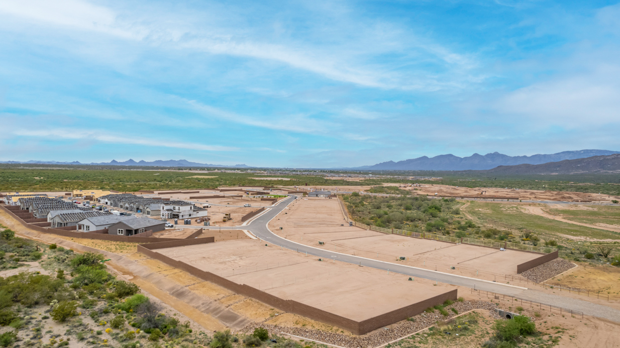 Introducing The River plan at The Oasis at Rocking K, a standout two-story new home that epitomizes spacious living and modern amenities in the scenic backdrop of Vail, Arizona. Nestled within this master-planned community, The River offers an impressive 2,396 square feet of living space, making it the largest floorplan available at The Oasis. This home is intentionally designed to accommodate the needs of growing families, with five bedrooms and three bathrooms, ensuring plenty of space for everyone.  The exterior of The River plan exudes charm and character, with its Spanish lace stucco finish and tile roof that blends seamlessly into the picturesque surroundings. The home’s front yard is meticulously landscaped with auto drip irrigation, providing a welcoming entrance to this beautiful residence.  Upon entering The River, you'll be greeted by a bright and inviting great room that flows effortlessly into the dining room and kitchen, creating a harmonious space perfect for entertaining or family gatherings. The kitchen is a chef’s day dream, featuring quartz countertops, 42” shaker-style cabinets, and stainless steel appliances, all designed to inspire culinary creativity. The main floor also includes the luxurious owner’s suite, which serves as a private sanctuary. This suite features a spacious walk-in closet and an en-suite bathroom with dual vanities, a walk-in shower, and a soaking tub, providing the perfect retreat at the end of the day. Additionally, a second bedroom on the main floor offers flexibility, ideal for guests or a home office.  As you ascend to the second story, you'll find three additional bedrooms, all with easy access to a full bathroom. A generous loft area on the second floor offers additional living space, ideal for a media room, play area, or home gym.  The River plan is not just about style and space; it’s also about modern convenience and energy efficiency. The home is equipped with D.R. Horton’s Home is Connected® Smart Home package, which includes a smart thermostat, video doorbell, keyless entry, Wi-Fi-enabled garage door opener, and Deako light switches, ensuring that your home is as functional as it is beautiful. Additionally, the home meets the DOE Zero Energy Ready Home standards, featuring energy-efficient elements such as spray foam insulation, a tankless water heater, LED lighting throughout and more.  Living at The Oasis at Rocking K means more than just owning a home; it means being part of a vibrant community. With access to amenities like ramadas, picnic areas, walking paths, and recreational fields, plus the greater Rocking K master-planned neighborhood’s splashpad, event lawn, playground, and events, there’s always something to do. Residents also enjoy the convenience of nearby schools, shopping, dining, and outdoor recreational opportunities, making The Oasis at Rocking K the perfect place to call home.  The River plan at The Oasis at Rocking K is where space, style, and smart living converge, offering a home designed for the way you live today.