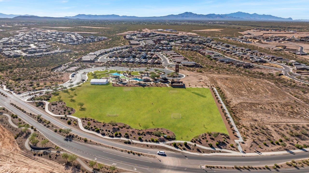 Introducing The River plan at The Oasis at Rocking K, a standout two-story new home that epitomizes spacious living and modern amenities in the scenic backdrop of Vail, Arizona. Nestled within this master-planned community, The River offers an impressive 2,396 square feet of living space, making it the largest floorplan available at The Oasis. This home is intentionally designed to accommodate the needs of growing families, with five bedrooms and three bathrooms, ensuring plenty of space for everyone.  The exterior of The River plan exudes charm and character, with its Spanish lace stucco finish and tile roof that blends seamlessly into the picturesque surroundings. The home’s front yard is meticulously landscaped with auto drip irrigation, providing a welcoming entrance to this beautiful residence.  Upon entering The River, you'll be greeted by a bright and inviting great room that flows effortlessly into the dining room and kitchen, creating a harmonious space perfect for entertaining or family gatherings. The kitchen is a chef’s day dream, featuring quartz countertops, 42” shaker-style cabinets, and stainless steel appliances, all designed to inspire culinary creativity. The main floor also includes the luxurious owner’s suite, which serves as a private sanctuary. This suite features a spacious walk-in closet and an en-suite bathroom with dual vanities, a walk-in shower, and a soaking tub, providing the perfect retreat at the end of the day. Additionally, a second bedroom on the main floor offers flexibility, ideal for guests or a home office.  As you ascend to the second story, you'll find three additional bedrooms, all with easy access to a full bathroom. A generous loft area on the second floor offers additional living space, ideal for a media room, play area, or home gym.  The River plan is not just about style and space; it’s also about modern convenience and energy efficiency. The home is equipped with D.R. Horton’s Home is Connected® Smart Home package, which includes a smart thermostat, video doorbell, keyless entry, Wi-Fi-enabled garage door opener, and Deako light switches, ensuring that your home is as functional as it is beautiful. Additionally, the home meets the DOE Zero Energy Ready Home standards, featuring energy-efficient elements such as spray foam insulation, a tankless water heater, LED lighting throughout and more.  Living at The Oasis at Rocking K means more than just owning a home; it means being part of a vibrant community. With access to amenities like ramadas, picnic areas, walking paths, and recreational fields, plus the greater Rocking K master-planned neighborhood’s splashpad, event lawn, playground, and events, there’s always something to do. Residents also enjoy the convenience of nearby schools, shopping, dining, and outdoor recreational opportunities, making The Oasis at Rocking K the perfect place to call home.  The River plan at The Oasis at Rocking K is where space, style, and smart living converge, offering a home designed for the way you live today.