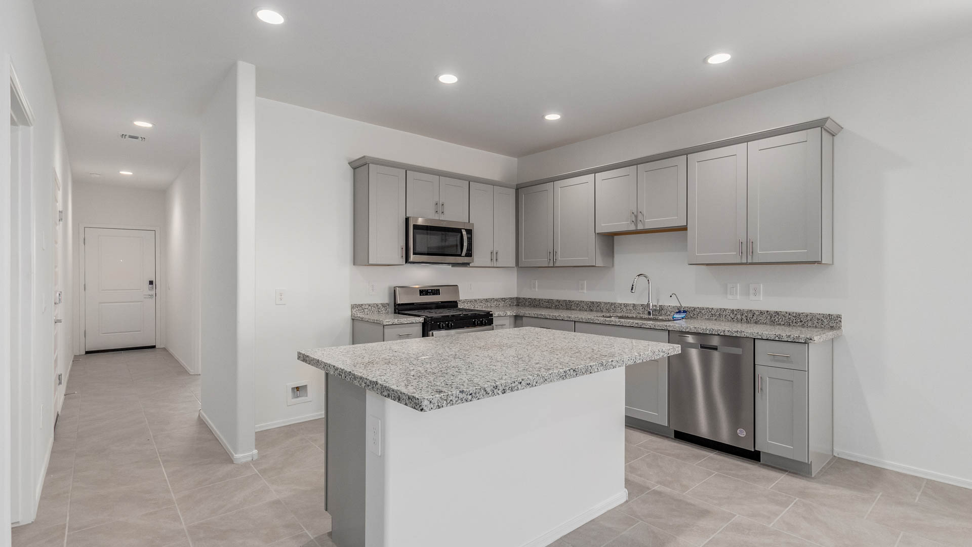 The Parker floor plan is one of the expansive new homes featured at The Oasis at Rocking K in Vail, Arizona. This vibrant community is nestled against the backdrop of the Rincon Mountains. The Parker stands out as a spacious single-story new home, offering 1,914 square feet of living space, making it the largest single-story floorplan available in this community.  The Parker is a reflection of elegance that defines The Oasis at Rocking K. The beautifully landscaped front yard, complete with an irrigation system, enhances the curb appeal, with a covered front porch.  Step into a well-planned layout that effortlessly balances functionality. The Parker features five bedrooms, including a private primary suite with a walk-in closet and en-suite bathroom. The additional bedrooms are thoughtfully situated to provide privacy and comfort, with easy access to two full bathrooms.  The heart of The Parker is the kitchen, which seamlessly connects to the dining room and great room. The kitchen is equipped with high-end finishes, including quartz countertops, shaker-style cabinets, and stainless-steel appliances. A generous pantry and plenty of cabinet space ensure that storage is never an issue.  The Parker includes a covered back patio, perfect for enjoying the tranquility of the surrounding landscape. Inside, the home features durable wood-look tile flooring in the main living areas, adding warmth and elegance to the space.  The Parker comes equipped with the Home is Connected® Smart Home package. This includes a smart thermostat, video doorbell, keyless entry, and more. Additionally, the home meets DOE Zero Energy Ready Home standards, with features like spray foam insulation and tankless water heaters, ensuring long-term savings and a reduced environmental footprint.  Living in The Oasis at Rocking K means enjoying a community rich in amenities. Whether you’re seeking a peaceful retreat or an active lifestyle, The Parker at The Oasis at Rocking K offers the perfect home base.