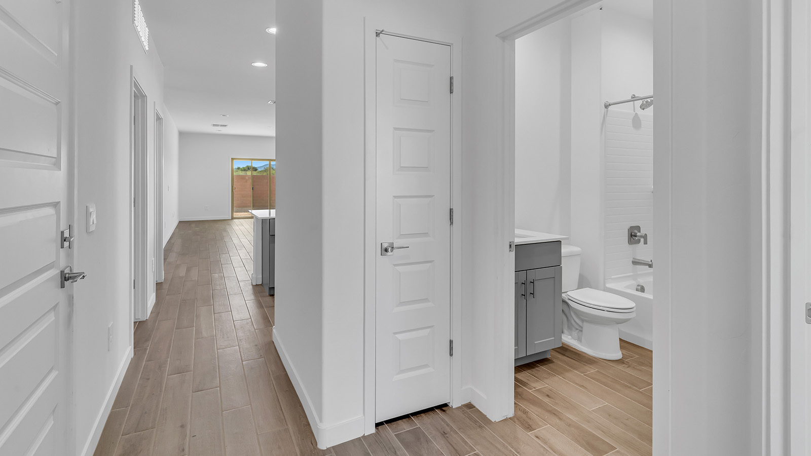 The Parker floor plan is one of the expansive new homes featured at The Oasis at Rocking K in Vail, Arizona. This vibrant community is nestled against the backdrop of the Rincon Mountains. The Parker stands out as a spacious single-story new home, offering 1,914 square feet of living space, making it the largest single-story floorplan available in this community.  The Parker is a reflection of elegance that defines The Oasis at Rocking K. The beautifully landscaped front yard, complete with an irrigation system, enhances the curb appeal, with a covered front porch.  Step into a well-planned layout that effortlessly balances functionality. The Parker features five bedrooms, including a private primary suite with a walk-in closet and en-suite bathroom. The additional bedrooms are thoughtfully situated to provide privacy and comfort, with easy access to two full bathrooms.  The heart of The Parker is the kitchen, which seamlessly connects to the dining room and great room. The kitchen is equipped with high-end finishes, including quartz countertops, shaker-style cabinets, and stainless-steel appliances. A generous pantry and plenty of cabinet space ensure that storage is never an issue.  The Parker includes a covered back patio, perfect for enjoying the tranquility of the surrounding landscape. Inside, the home features durable wood-look tile flooring in the main living areas, adding warmth and elegance to the space.  The Parker comes equipped with the Home is Connected® Smart Home package. This includes a smart thermostat, video doorbell, keyless entry, and more. Additionally, the home meets DOE Zero Energy Ready Home standards, with features like spray foam insulation and tankless water heaters, ensuring long-term savings and a reduced environmental footprint.  Living in The Oasis at Rocking K means enjoying a community rich in amenities. Whether you’re seeking a peaceful retreat or an active lifestyle, The Parker at The Oasis at Rocking K offers the perfect home base.