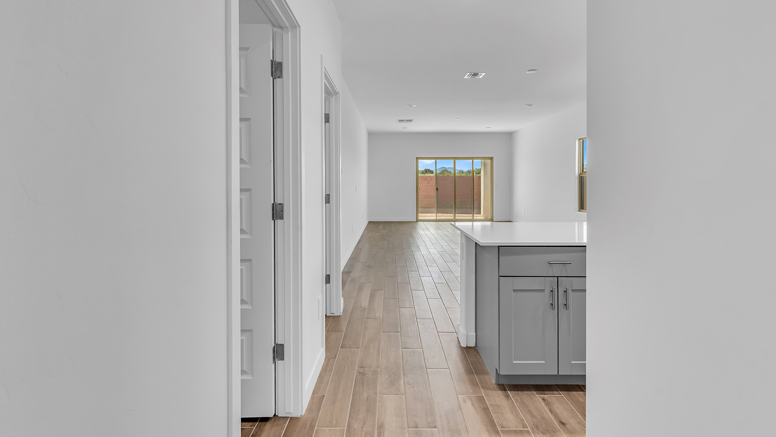 The Parker floor plan is one of the expansive new homes featured at The Oasis at Rocking K in Vail, Arizona. This vibrant community is nestled against the backdrop of the Rincon Mountains. The Parker stands out as a spacious single-story new home, offering 1,914 square feet of living space, making it the largest single-story floorplan available in this community.  The Parker is a reflection of elegance that defines The Oasis at Rocking K. The beautifully landscaped front yard, complete with an irrigation system, enhances the curb appeal, with a covered front porch.  Step into a well-planned layout that effortlessly balances functionality. The Parker features five bedrooms, including a private primary suite with a walk-in closet and en-suite bathroom. The additional bedrooms are thoughtfully situated to provide privacy and comfort, with easy access to two full bathrooms.  The heart of The Parker is the kitchen, which seamlessly connects to the dining room and great room. The kitchen is equipped with high-end finishes, including quartz countertops, shaker-style cabinets, and stainless-steel appliances. A generous pantry and plenty of cabinet space ensure that storage is never an issue.  The Parker includes a covered back patio, perfect for enjoying the tranquility of the surrounding landscape. Inside, the home features durable wood-look tile flooring in the main living areas, adding warmth and elegance to the space.  The Parker comes equipped with the Home is Connected® Smart Home package. This includes a smart thermostat, video doorbell, keyless entry, and more. Additionally, the home meets DOE Zero Energy Ready Home standards, with features like spray foam insulation and tankless water heaters, ensuring long-term savings and a reduced environmental footprint.  Living in The Oasis at Rocking K means enjoying a community rich in amenities. Whether you’re seeking a peaceful retreat or an active lifestyle, The Parker at The Oasis at Rocking K offers the perfect home base.