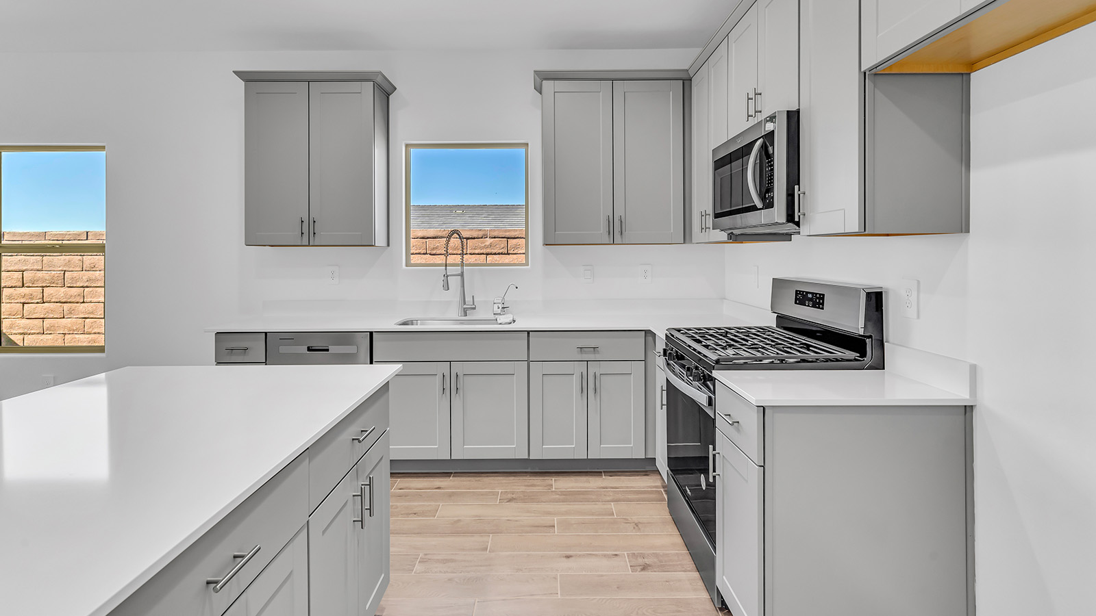 The Parker floor plan is one of the expansive new homes featured at The Oasis at Rocking K in Vail, Arizona. This vibrant community is nestled against the backdrop of the Rincon Mountains. The Parker stands out as a spacious single-story new home, offering 1,914 square feet of living space, making it the largest single-story floorplan available in this community.  The Parker is a reflection of elegance that defines The Oasis at Rocking K. The beautifully landscaped front yard, complete with an irrigation system, enhances the curb appeal, with a covered front porch.  Step into a well-planned layout that effortlessly balances functionality. The Parker features five bedrooms, including a private primary suite with a walk-in closet and en-suite bathroom. The additional bedrooms are thoughtfully situated to provide privacy and comfort, with easy access to two full bathrooms.  The heart of The Parker is the kitchen, which seamlessly connects to the dining room and great room. The kitchen is equipped with high-end finishes, including quartz countertops, shaker-style cabinets, and stainless-steel appliances. A generous pantry and plenty of cabinet space ensure that storage is never an issue.  The Parker includes a covered back patio, perfect for enjoying the tranquility of the surrounding landscape. Inside, the home features durable wood-look tile flooring in the main living areas, adding warmth and elegance to the space.  The Parker comes equipped with the Home is Connected® Smart Home package. This includes a smart thermostat, video doorbell, keyless entry, and more. Additionally, the home meets DOE Zero Energy Ready Home standards, with features like spray foam insulation and tankless water heaters, ensuring long-term savings and a reduced environmental footprint.  Living in The Oasis at Rocking K means enjoying a community rich in amenities. Whether you’re seeking a peaceful retreat or an active lifestyle, The Parker at The Oasis at Rocking K offers the perfect home base.