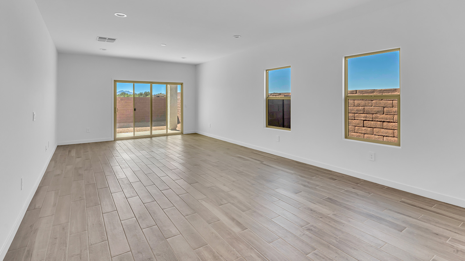 The Parker floor plan is one of the expansive new homes featured at The Oasis at Rocking K in Vail, Arizona. This vibrant community is nestled against the backdrop of the Rincon Mountains. The Parker stands out as a spacious single-story new home, offering 1,914 square feet of living space, making it the largest single-story floorplan available in this community.  The Parker is a reflection of elegance that defines The Oasis at Rocking K. The beautifully landscaped front yard, complete with an irrigation system, enhances the curb appeal, with a covered front porch.  Step into a well-planned layout that effortlessly balances functionality. The Parker features five bedrooms, including a private primary suite with a walk-in closet and en-suite bathroom. The additional bedrooms are thoughtfully situated to provide privacy and comfort, with easy access to two full bathrooms.  The heart of The Parker is the kitchen, which seamlessly connects to the dining room and great room. The kitchen is equipped with high-end finishes, including quartz countertops, shaker-style cabinets, and stainless-steel appliances. A generous pantry and plenty of cabinet space ensure that storage is never an issue.  The Parker includes a covered back patio, perfect for enjoying the tranquility of the surrounding landscape. Inside, the home features durable wood-look tile flooring in the main living areas, adding warmth and elegance to the space.  The Parker comes equipped with the Home is Connected® Smart Home package. This includes a smart thermostat, video doorbell, keyless entry, and more. Additionally, the home meets DOE Zero Energy Ready Home standards, with features like spray foam insulation and tankless water heaters, ensuring long-term savings and a reduced environmental footprint.  Living in The Oasis at Rocking K means enjoying a community rich in amenities. Whether you’re seeking a peaceful retreat or an active lifestyle, The Parker at The Oasis at Rocking K offers the perfect home base.