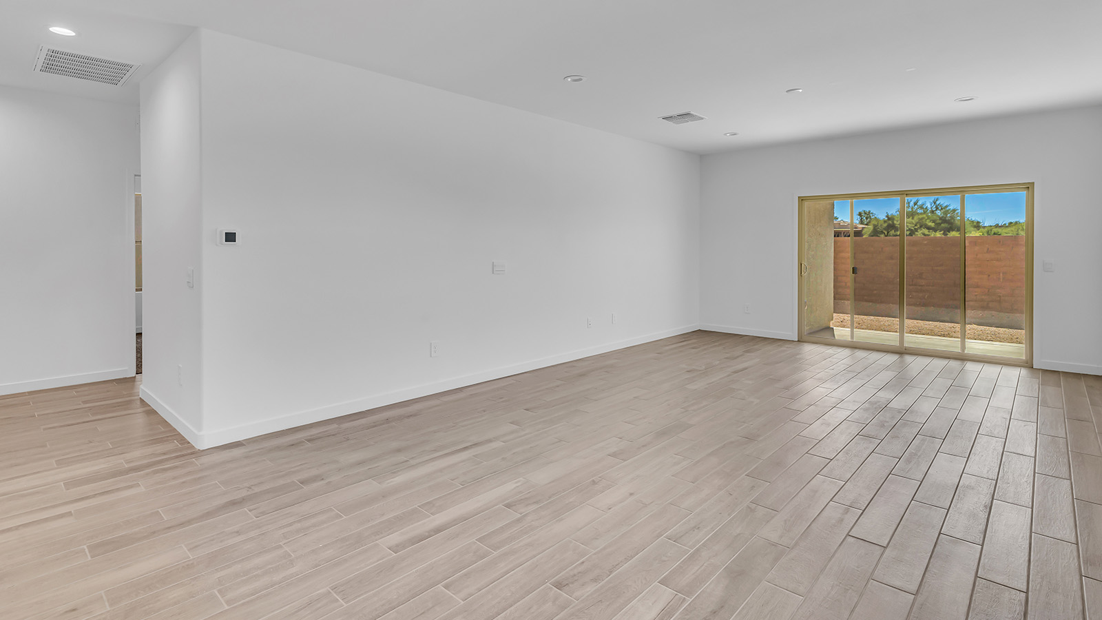 The Parker floor plan is one of the expansive new homes featured at The Oasis at Rocking K in Vail, Arizona. This vibrant community is nestled against the backdrop of the Rincon Mountains. The Parker stands out as a spacious single-story new home, offering 1,914 square feet of living space, making it the largest single-story floorplan available in this community.  The Parker is a reflection of elegance that defines The Oasis at Rocking K. The beautifully landscaped front yard, complete with an irrigation system, enhances the curb appeal, with a covered front porch.  Step into a well-planned layout that effortlessly balances functionality. The Parker features five bedrooms, including a private primary suite with a walk-in closet and en-suite bathroom. The additional bedrooms are thoughtfully situated to provide privacy and comfort, with easy access to two full bathrooms.  The heart of The Parker is the kitchen, which seamlessly connects to the dining room and great room. The kitchen is equipped with high-end finishes, including quartz countertops, shaker-style cabinets, and stainless-steel appliances. A generous pantry and plenty of cabinet space ensure that storage is never an issue.  The Parker includes a covered back patio, perfect for enjoying the tranquility of the surrounding landscape. Inside, the home features durable wood-look tile flooring in the main living areas, adding warmth and elegance to the space.  The Parker comes equipped with the Home is Connected® Smart Home package. This includes a smart thermostat, video doorbell, keyless entry, and more. Additionally, the home meets DOE Zero Energy Ready Home standards, with features like spray foam insulation and tankless water heaters, ensuring long-term savings and a reduced environmental footprint.  Living in The Oasis at Rocking K means enjoying a community rich in amenities. Whether you’re seeking a peaceful retreat or an active lifestyle, The Parker at The Oasis at Rocking K offers the perfect home base.