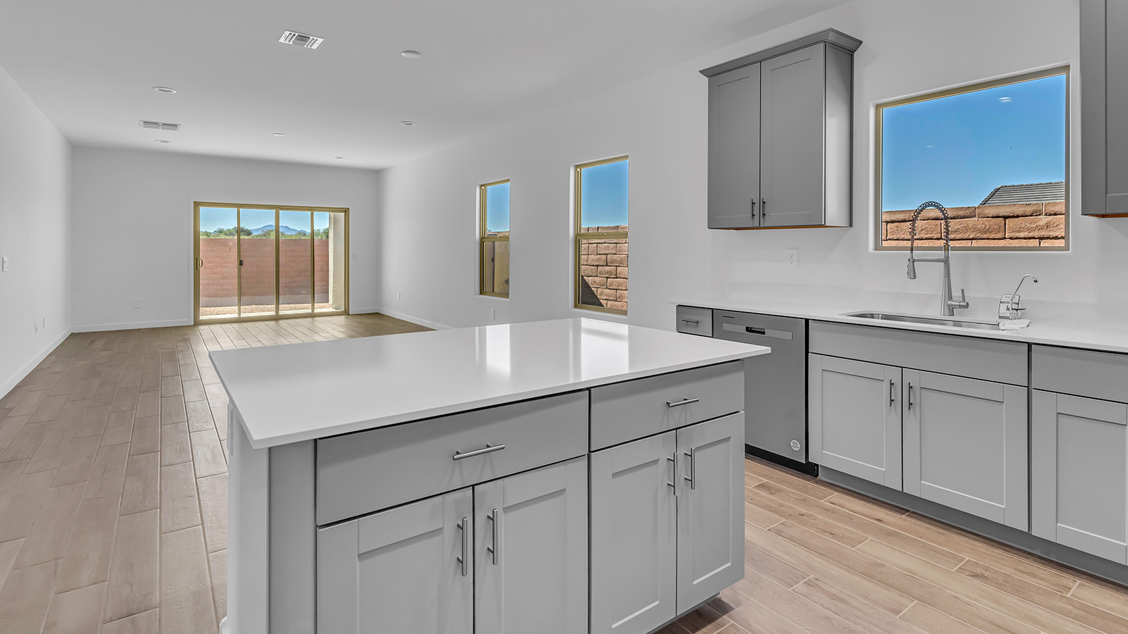 The Parker floor plan is one of the expansive new homes featured at The Oasis at Rocking K in Vail, Arizona. This vibrant community is nestled against the backdrop of the Rincon Mountains. The Parker stands out as a spacious single-story new home, offering 1,914 square feet of living space, making it the largest single-story floorplan available in this community.  The Parker is a reflection of elegance that defines The Oasis at Rocking K. The beautifully landscaped front yard, complete with an irrigation system, enhances the curb appeal, with a covered front porch.  Step into a well-planned layout that effortlessly balances functionality. The Parker features five bedrooms, including a private primary suite with a walk-in closet and en-suite bathroom. The additional bedrooms are thoughtfully situated to provide privacy and comfort, with easy access to two full bathrooms.  The heart of The Parker is the kitchen, which seamlessly connects to the dining room and great room. The kitchen is equipped with high-end finishes, including quartz countertops, shaker-style cabinets, and stainless-steel appliances. A generous pantry and plenty of cabinet space ensure that storage is never an issue.  The Parker includes a covered back patio, perfect for enjoying the tranquility of the surrounding landscape. Inside, the home features durable wood-look tile flooring in the main living areas, adding warmth and elegance to the space.  The Parker comes equipped with the Home is Connected® Smart Home package. This includes a smart thermostat, video doorbell, keyless entry, and more. Additionally, the home meets DOE Zero Energy Ready Home standards, with features like spray foam insulation and tankless water heaters, ensuring long-term savings and a reduced environmental footprint.  Living in The Oasis at Rocking K means enjoying a community rich in amenities. Whether you’re seeking a peaceful retreat or an active lifestyle, The Parker at The Oasis at Rocking K offers the perfect home base.