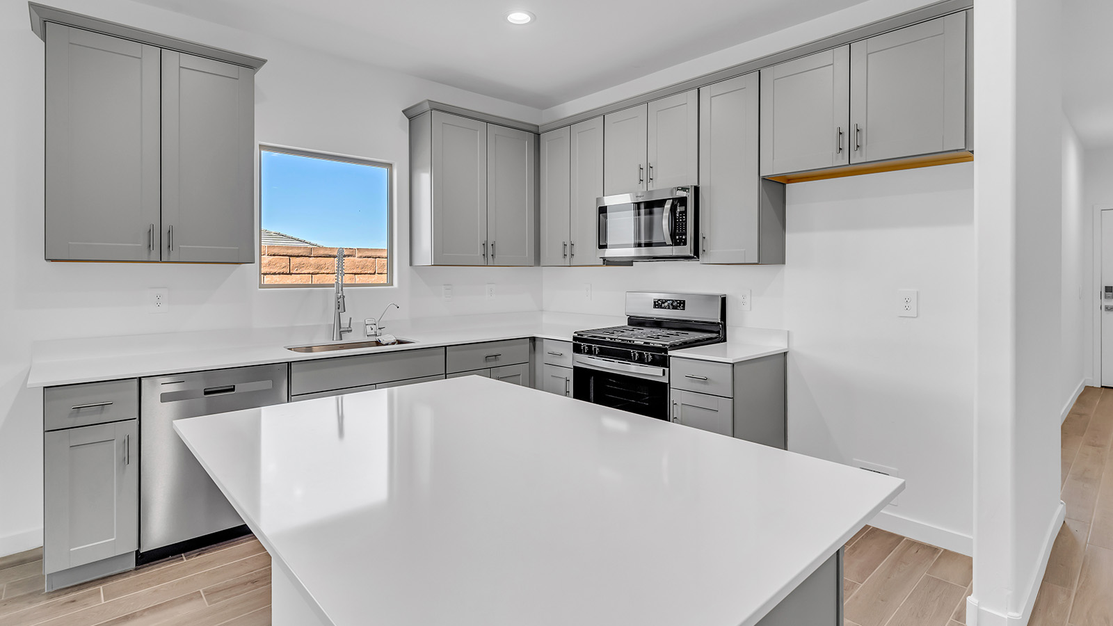 The Parker floor plan is one of the expansive new homes featured at The Oasis at Rocking K in Vail, Arizona. This vibrant community is nestled against the backdrop of the Rincon Mountains. The Parker stands out as a spacious single-story new home, offering 1,914 square feet of living space, making it the largest single-story floorplan available in this community.  The Parker is a reflection of elegance that defines The Oasis at Rocking K. The beautifully landscaped front yard, complete with an irrigation system, enhances the curb appeal, with a covered front porch.  Step into a well-planned layout that effortlessly balances functionality. The Parker features five bedrooms, including a private primary suite with a walk-in closet and en-suite bathroom. The additional bedrooms are thoughtfully situated to provide privacy and comfort, with easy access to two full bathrooms.  The heart of The Parker is the kitchen, which seamlessly connects to the dining room and great room. The kitchen is equipped with high-end finishes, including quartz countertops, shaker-style cabinets, and stainless-steel appliances. A generous pantry and plenty of cabinet space ensure that storage is never an issue.  The Parker includes a covered back patio, perfect for enjoying the tranquility of the surrounding landscape. Inside, the home features durable wood-look tile flooring in the main living areas, adding warmth and elegance to the space.  The Parker comes equipped with the Home is Connected® Smart Home package. This includes a smart thermostat, video doorbell, keyless entry, and more. Additionally, the home meets DOE Zero Energy Ready Home standards, with features like spray foam insulation and tankless water heaters, ensuring long-term savings and a reduced environmental footprint.  Living in The Oasis at Rocking K means enjoying a community rich in amenities. Whether you’re seeking a peaceful retreat or an active lifestyle, The Parker at The Oasis at Rocking K offers the perfect home base.