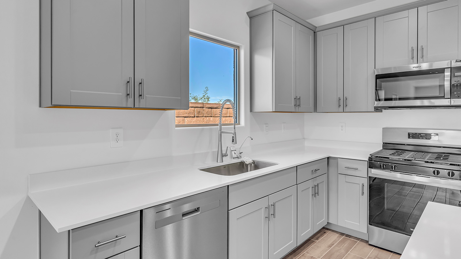 The Parker floor plan is one of the expansive new homes featured at The Oasis at Rocking K in Vail, Arizona. This vibrant community is nestled against the backdrop of the Rincon Mountains. The Parker stands out as a spacious single-story new home, offering 1,914 square feet of living space, making it the largest single-story floorplan available in this community.  The Parker is a reflection of elegance that defines The Oasis at Rocking K. The beautifully landscaped front yard, complete with an irrigation system, enhances the curb appeal, with a covered front porch.  Step into a well-planned layout that effortlessly balances functionality. The Parker features five bedrooms, including a private primary suite with a walk-in closet and en-suite bathroom. The additional bedrooms are thoughtfully situated to provide privacy and comfort, with easy access to two full bathrooms.  The heart of The Parker is the kitchen, which seamlessly connects to the dining room and great room. The kitchen is equipped with high-end finishes, including quartz countertops, shaker-style cabinets, and stainless-steel appliances. A generous pantry and plenty of cabinet space ensure that storage is never an issue.  The Parker includes a covered back patio, perfect for enjoying the tranquility of the surrounding landscape. Inside, the home features durable wood-look tile flooring in the main living areas, adding warmth and elegance to the space.  The Parker comes equipped with the Home is Connected® Smart Home package. This includes a smart thermostat, video doorbell, keyless entry, and more. Additionally, the home meets DOE Zero Energy Ready Home standards, with features like spray foam insulation and tankless water heaters, ensuring long-term savings and a reduced environmental footprint.  Living in The Oasis at Rocking K means enjoying a community rich in amenities. Whether you’re seeking a peaceful retreat or an active lifestyle, The Parker at The Oasis at Rocking K offers the perfect home base.