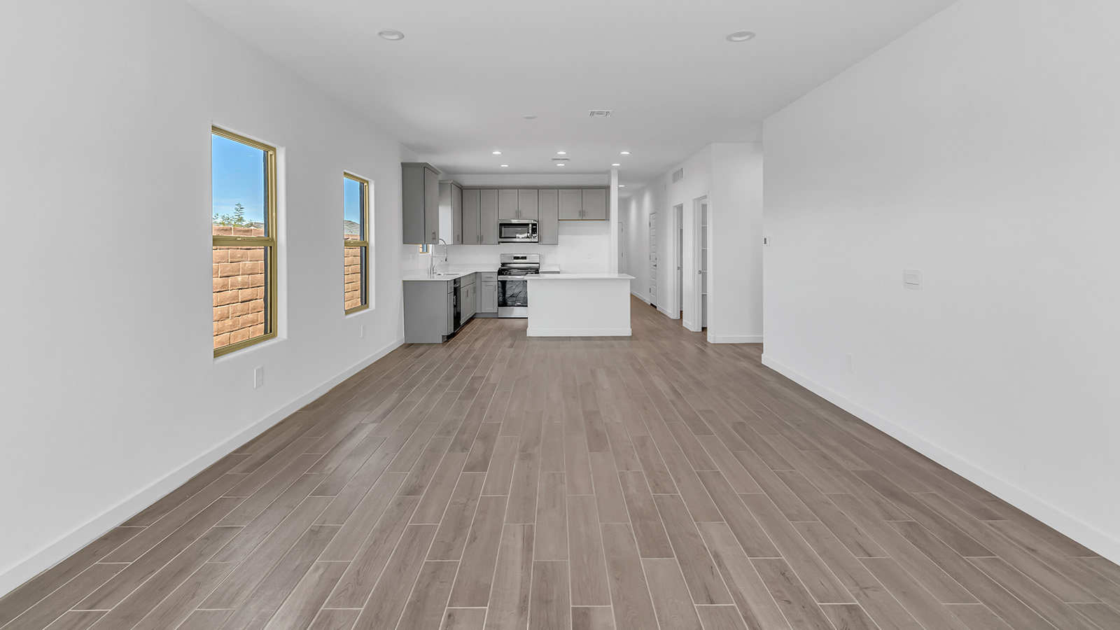 The Parker floor plan is one of the expansive new homes featured at The Oasis at Rocking K in Vail, Arizona. This vibrant community is nestled against the backdrop of the Rincon Mountains. The Parker stands out as a spacious single-story new home, offering 1,914 square feet of living space, making it the largest single-story floorplan available in this community.  The Parker is a reflection of elegance that defines The Oasis at Rocking K. The beautifully landscaped front yard, complete with an irrigation system, enhances the curb appeal, with a covered front porch.  Step into a well-planned layout that effortlessly balances functionality. The Parker features five bedrooms, including a private primary suite with a walk-in closet and en-suite bathroom. The additional bedrooms are thoughtfully situated to provide privacy and comfort, with easy access to two full bathrooms.  The heart of The Parker is the kitchen, which seamlessly connects to the dining room and great room. The kitchen is equipped with high-end finishes, including quartz countertops, shaker-style cabinets, and stainless-steel appliances. A generous pantry and plenty of cabinet space ensure that storage is never an issue.  The Parker includes a covered back patio, perfect for enjoying the tranquility of the surrounding landscape. Inside, the home features durable wood-look tile flooring in the main living areas, adding warmth and elegance to the space.  The Parker comes equipped with the Home is Connected® Smart Home package. This includes a smart thermostat, video doorbell, keyless entry, and more. Additionally, the home meets DOE Zero Energy Ready Home standards, with features like spray foam insulation and tankless water heaters, ensuring long-term savings and a reduced environmental footprint.  Living in The Oasis at Rocking K means enjoying a community rich in amenities. Whether you’re seeking a peaceful retreat or an active lifestyle, The Parker at The Oasis at Rocking K offers the perfect home base.