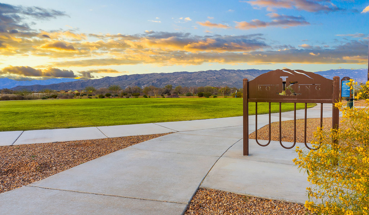 The Parker floor plan is one of the expansive new homes featured at The Oasis at Rocking K in Vail, Arizona. This vibrant community is nestled against the backdrop of the Rincon Mountains. The Parker stands out as a spacious single-story new home, offering 1,914 square feet of living space, making it the largest single-story floorplan available in this community.  The Parker is a reflection of elegance that defines The Oasis at Rocking K. The beautifully landscaped front yard, complete with an irrigation system, enhances the curb appeal, with a covered front porch.  Step into a well-planned layout that effortlessly balances functionality. The Parker features five bedrooms, including a private primary suite with a walk-in closet and en-suite bathroom. The additional bedrooms are thoughtfully situated to provide privacy and comfort, with easy access to two full bathrooms.  The heart of The Parker is the kitchen, which seamlessly connects to the dining room and great room. The kitchen is equipped with high-end finishes, including quartz countertops, shaker-style cabinets, and stainless-steel appliances. A generous pantry and plenty of cabinet space ensure that storage is never an issue.  The Parker includes a covered back patio, perfect for enjoying the tranquility of the surrounding landscape. Inside, the home features durable wood-look tile flooring in the main living areas, adding warmth and elegance to the space.  The Parker comes equipped with the Home is Connected® Smart Home package. This includes a smart thermostat, video doorbell, keyless entry, and more. Additionally, the home meets DOE Zero Energy Ready Home standards, with features like spray foam insulation and tankless water heaters, ensuring long-term savings and a reduced environmental footprint.  Living in The Oasis at Rocking K means enjoying a community rich in amenities. Whether you’re seeking a peaceful retreat or an active lifestyle, The Parker at The Oasis at Rocking K offers the perfect home base.