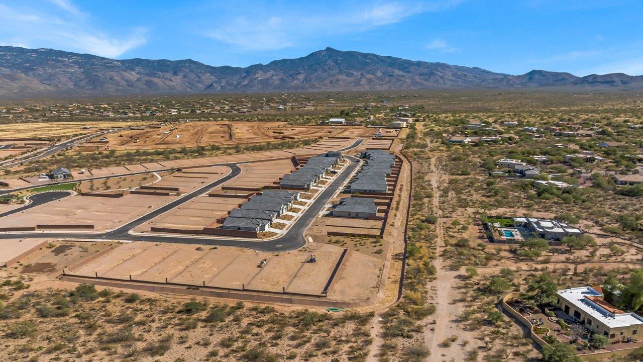 The Parker floor plan is one of the expansive new homes featured at The Oasis at Rocking K in Vail, Arizona. This vibrant community is nestled against the backdrop of the Rincon Mountains. The Parker stands out as a spacious single-story new home, offering 1,914 square feet of living space, making it the largest single-story floorplan available in this community.  The Parker is a reflection of elegance that defines The Oasis at Rocking K. The beautifully landscaped front yard, complete with an irrigation system, enhances the curb appeal, with a covered front porch.  Step into a well-planned layout that effortlessly balances functionality. The Parker features five bedrooms, including a private primary suite with a walk-in closet and en-suite bathroom. The additional bedrooms are thoughtfully situated to provide privacy and comfort, with easy access to two full bathrooms.  The heart of The Parker is the kitchen, which seamlessly connects to the dining room and great room. The kitchen is equipped with high-end finishes, including quartz countertops, shaker-style cabinets, and stainless-steel appliances. A generous pantry and plenty of cabinet space ensure that storage is never an issue.  The Parker includes a covered back patio, perfect for enjoying the tranquility of the surrounding landscape. Inside, the home features durable wood-look tile flooring in the main living areas, adding warmth and elegance to the space.  The Parker comes equipped with the Home is Connected® Smart Home package. This includes a smart thermostat, video doorbell, keyless entry, and more. Additionally, the home meets DOE Zero Energy Ready Home standards, with features like spray foam insulation and tankless water heaters, ensuring long-term savings and a reduced environmental footprint.  Living in The Oasis at Rocking K means enjoying a community rich in amenities. Whether you’re seeking a peaceful retreat or an active lifestyle, The Parker at The Oasis at Rocking K offers the perfect home base.