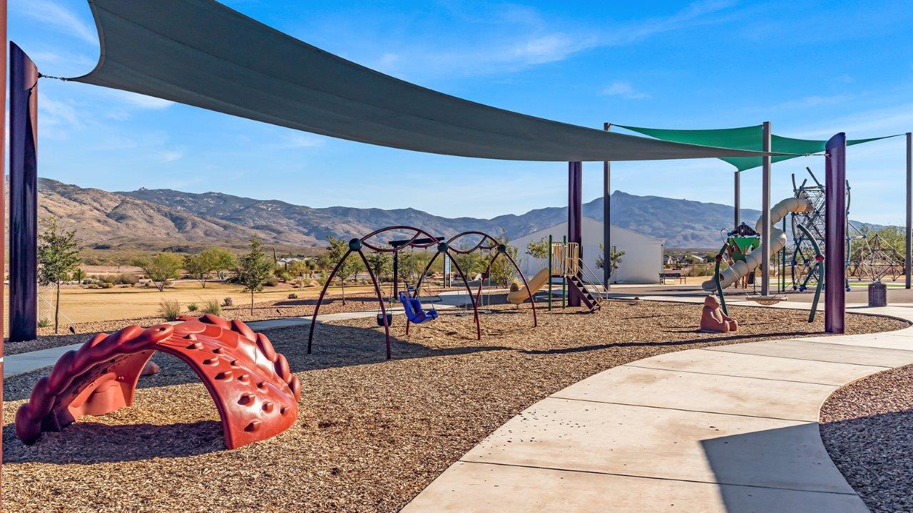 The Parker floor plan is one of the expansive new homes featured at The Oasis at Rocking K in Vail, Arizona. This vibrant community is nestled against the backdrop of the Rincon Mountains. The Parker stands out as a spacious single-story new home, offering 1,914 square feet of living space, making it the largest single-story floorplan available in this community.  The Parker is a reflection of elegance that defines The Oasis at Rocking K. The beautifully landscaped front yard, complete with an irrigation system, enhances the curb appeal, with a covered front porch.  Step into a well-planned layout that effortlessly balances functionality. The Parker features five bedrooms, including a private primary suite with a walk-in closet and en-suite bathroom. The additional bedrooms are thoughtfully situated to provide privacy and comfort, with easy access to two full bathrooms.  The heart of The Parker is the kitchen, which seamlessly connects to the dining room and great room. The kitchen is equipped with high-end finishes, including quartz countertops, shaker-style cabinets, and stainless-steel appliances. A generous pantry and plenty of cabinet space ensure that storage is never an issue.  The Parker includes a covered back patio, perfect for enjoying the tranquility of the surrounding landscape. Inside, the home features durable wood-look tile flooring in the main living areas, adding warmth and elegance to the space.  The Parker comes equipped with the Home is Connected® Smart Home package. This includes a smart thermostat, video doorbell, keyless entry, and more. Additionally, the home meets DOE Zero Energy Ready Home standards, with features like spray foam insulation and tankless water heaters, ensuring long-term savings and a reduced environmental footprint.  Living in The Oasis at Rocking K means enjoying a community rich in amenities. Whether you’re seeking a peaceful retreat or an active lifestyle, The Parker at The Oasis at Rocking K offers the perfect home base.