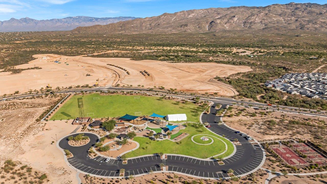 The Parker floor plan is one of the expansive new homes featured at The Oasis at Rocking K in Vail, Arizona. This vibrant community is nestled against the backdrop of the Rincon Mountains. The Parker stands out as a spacious single-story new home, offering 1,914 square feet of living space, making it the largest single-story floorplan available in this community.  The Parker is a reflection of elegance that defines The Oasis at Rocking K. The beautifully landscaped front yard, complete with an irrigation system, enhances the curb appeal, with a covered front porch.  Step into a well-planned layout that effortlessly balances functionality. The Parker features five bedrooms, including a private primary suite with a walk-in closet and en-suite bathroom. The additional bedrooms are thoughtfully situated to provide privacy and comfort, with easy access to two full bathrooms.  The heart of The Parker is the kitchen, which seamlessly connects to the dining room and great room. The kitchen is equipped with high-end finishes, including quartz countertops, shaker-style cabinets, and stainless-steel appliances. A generous pantry and plenty of cabinet space ensure that storage is never an issue.  The Parker includes a covered back patio, perfect for enjoying the tranquility of the surrounding landscape. Inside, the home features durable wood-look tile flooring in the main living areas, adding warmth and elegance to the space.  The Parker comes equipped with the Home is Connected® Smart Home package. This includes a smart thermostat, video doorbell, keyless entry, and more. Additionally, the home meets DOE Zero Energy Ready Home standards, with features like spray foam insulation and tankless water heaters, ensuring long-term savings and a reduced environmental footprint.  Living in The Oasis at Rocking K means enjoying a community rich in amenities. Whether you’re seeking a peaceful retreat or an active lifestyle, The Parker at The Oasis at Rocking K offers the perfect home base.