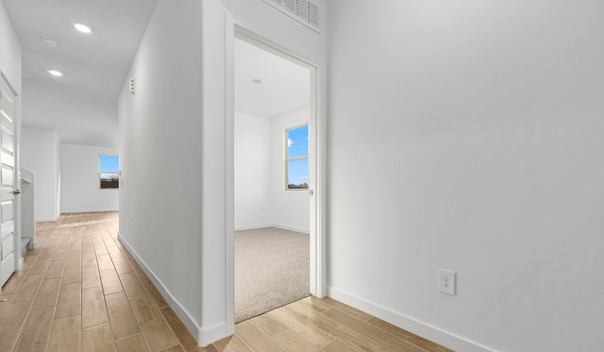 The Juniper at The Oasis at Rocking K presents an exceptional living experience that blends comfort and style within its thoughtfully crafted 2,439 square feet. This two-story, four-bedroom, two full bathroom, and one half-bathroom home offers space and room to grow. This home features a three-car tandem garage. The Juniper home is designed to cater to a variety of lifestyle needs, offering both privacy and open spaces that encourage togetherness. As you step into the welcoming entryway, you're led into a spacious great room that seamlessly connects with the dining room and kitchen, creating a perfect setting for daily living and entertaining. The kitchen is a true culinary delight, featuring elegant countertops, shaker-style cabinets, and a modern layout that includes a pantry for additional storage.  Welcome to The Juniper at Oasis at Rocking K, a premier D.R. Horton new home community nestled in the picturesque landscapes of Vail, Arizona, where new homes blend seamlessly with the breathtaking surroundings of the Rincon Mountains. Experience the perfect balance of tranquility and modern convenience in this master-planned neighborhood, designed to offer a lifestyle that caters to families, nature enthusiasts, and anyone seeking a peaceful yet connected community.  Each home in The Oasis at Rocking K is equipped with D.R. Horton’s Home is Connected® Smart Home package, which includes a smart thermostat, video doorbell, keyless entry, Wi-Fi-enabled garage door opener, and Deako light switches. Additionally, these homes meet the stringent DOE Zero Energy Ready Home standards, making them not only comfortable and modern but also exceptionally energy efficient. With features like spray foam insulation, tankless water heaters and LED lighting, these homes are designed to reduce your environmental footprint and provide long-term savings on energy costs.  Living at Rocking K means being part of a vibrant, family-oriented community with a strong sense of connection among residents. The Oasis at Rocking K offers a variety of amenities, including ramadas, picnic tables, and grassy areas perfect for gatherings. Residents also have access to the greater Rocking K master-planned neighborhood amenities, such as a splashpad, large event lawn, walking paths, multipurpose fields, basketball and pickleball courts, and an innovative playground with a zip-line and jungle gym. The new K-8 school, set to open in 2025, is just one of the many features that make Rocking K ideal for families.  Life at Rocking K is further enriched by a lively calendar of lifestyle events, thoughtfully organized by the Rocking K Homeowners Association. These events are a cornerstone of community life, fostering a strong sense of connection among residents. Whether you’re looking to enjoy a quiet evening star gazing in the park or engage in fun activities with neighbors, there’s always something happening. The quarterly lifestyle calendar is packed with regular and seasonal events, including movie nights in the park, sports and summer camps for kids, and wine tasting events for adults. Families can join hiking groups, participate in trivia nights, or enjoy the various holiday celebrations. The community comes alive during the holidays with loads of themed events, arts and crafts fairs, and car shows. Rocking K’s commitment to providing a dynamic and engaging environment ensures that there’s always an opportunity to make memories and build lasting friendships right in your neighborhood.  Residents of Rocking K benefit from easy access to I-10, making commutes to Tucson and surrounding areas a breeze. The community is close to major employers such as Davis-Monthan Air Force Base, Raytheon, and the University of Arizona, as well as top-notch healthcare facilities like TMC Rincon and Northwest Hospital East. The nearby Houghton Town Center and Houghton Rd. business corridor offer convenient shopping, dining, and services.  For outdoor enthusiasts, Rocking K is surrounded by natural beauty and recreational opportunities. Explore the hiking and biking trails at Colossal Cave Mountain Park, Saguaro National Park East, and the Arizona Trail. Enjoy golfing at Del Lago Golf Course or take a short drive to Sonoita for a day trip to Arizona’s Wine Country. Whether it’s hiking, camping, or simply taking in the stunning views, Rocking K is your gateway to the great outdoors. With 360-degree mountain views, calm and quiet evenings, and a location that’s close to everything you need, Rocking K is truly a community where you can thrive. Experience the best of Arizona living at The Oasis at Rocking K, where your new home awaits in a community that offers everything you need for a fulfilling lifestyle.  *Images shown are for reference only. They depict the Juniper model home and include virtual staging and may not represent the actual home.