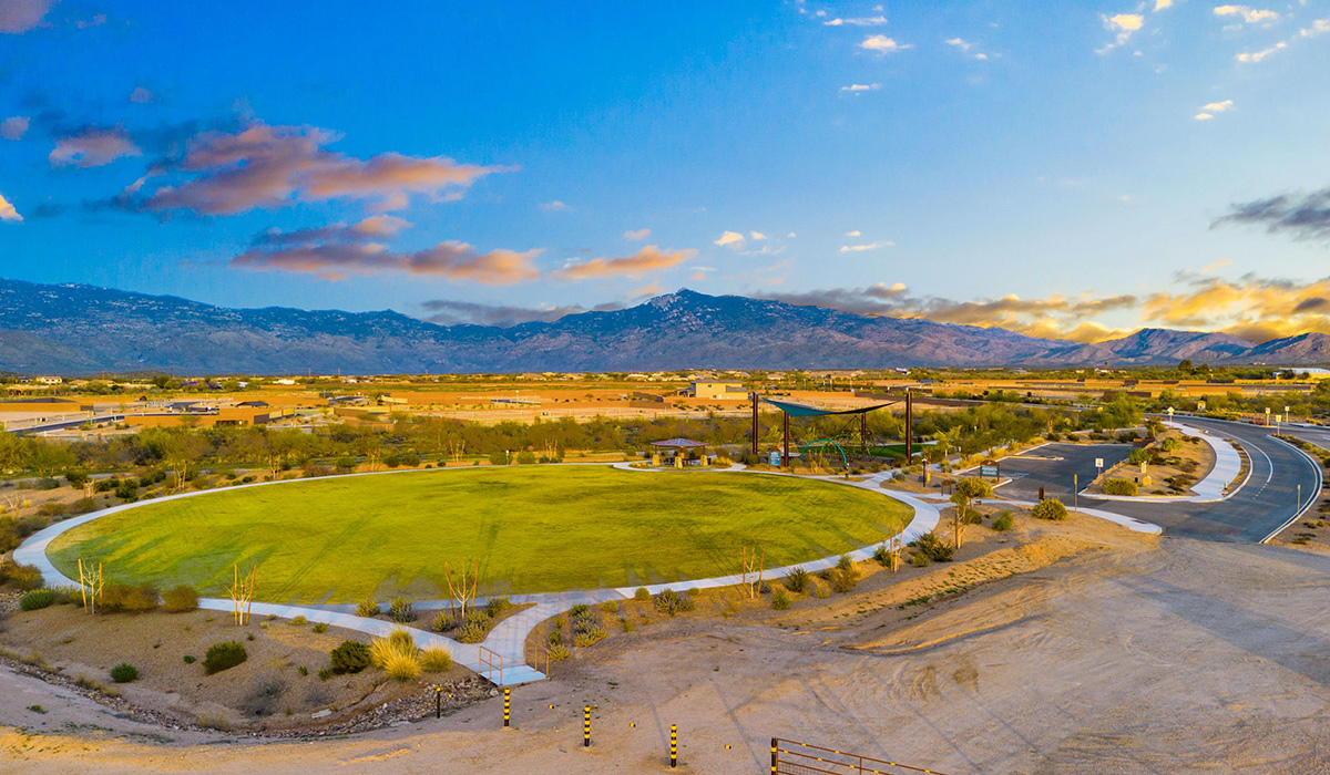 Welcome to The Oasis at Rocking K, a premier D.R. Horton new home community nestled in the picturesque landscapes of Vail, Arizona, where new homes blend seamlessly with the breathtaking surroundings of the Rincon Mountains. Experience the perfect balance of tranquility and modern convenience in this master-planned neighborhood, designed to offer a lifestyle that caters to families, nature enthusiasts, and anyone seeking a peaceful yet connected community.  The Oasis at Rocking K features five beautifully designed one-story floor plans ranging from 1,400 to 1,900 square feet, each crafted with the high-quality features and finishes D.R. Horton is known for. Homes in Rocking K feature a Spanish lace stucco exterior, tile roofs, and meticulously landscaped front yards with auto drip irrigation. Inside, you’ll find luxurious quartz countertops in the kitchens and bathrooms, 42” shaker-style cabinets with modern cabinet pulls, and wood-look tile flooring throughout the main living areas. Homes also include covered front porches and back patios, perfect for enjoying Arizona’s stunning sunsets and clear night skies.  Each home in The Oasis at Rocking K is equipped with D.R. Horton’s Home is Connected® Smart Home package, which includes a smart thermostat, video doorbell, keyless entry, Wi-Fi-enabled garage door opener, and Deako light switches. Additionally, these homes meet the stringent DOE Zero Energy Ready Home standards, making them not only comfortable and modern but also exceptionally energy-efficient. With features like spray foam insulation, tankless water heaters and LED lighting, these homes are designed to reduce your environmental footprint and provide long-term savings on energy costs.  Living at Rocking K means being part of a vibrant, family-oriented community with a strong sense of connection among residents. The Oasis at Rocking K offers a variety of amenities, including ramadas, picnic tables, and grassy areas perfect for gatherings. Residents also have access to the greater Rocking K master-planned neighborhood amenities, such as a splashpad, large event lawn, walking paths, multipurpose fields, basketball and pickleball courts, and an innovative playground with a zip-line and jungle gym. The new K-8 school, set to open in 2025, is just one of the many features that make Rocking K ideal for families.  Life at Rocking K is further enriched by a lively calendar of lifestyle events, thoughtfully organized by the Rocking K Homeowners Association. These events are a cornerstone of community life, fostering a strong sense of connection among residents. Whether you’re looking to enjoy a quiet evening star gazing in the park or engage in fun activities with neighbors, there’s always something happening. The quarterly lifestyle calendar is packed with regular and seasonal events, including movie nights in the park, sports and summer camps for kids, and wine tasting events for adults. Families can join hiking groups, participate in trivia nights, or enjoy the various holiday celebrations. The community comes alive during the holidays with loads of themed events, arts and crafts fairs, and car shows. Rocking K’s commitment to providing a dynamic and engaging environment ensures that there’s always an opportunity to make memories and build lasting friendships right in your neighborhood.   Residents of Rocking K benefit from easy access to I-10, making commutes to Tucson and surrounding areas a breeze. The community is close to major employers such as Davis-Monthan Air Force Base, Raytheon, and the University of Arizona, as well as top-notch healthcare facilities like TMC Rincon and Northwest Hospital East. The nearby Houghton Town Center and Houghton Rd. business corridor offer convenient shopping, dining, and services.  For outdoor enthusiasts, Rocking K is surrounded by natural beauty and recreational opportunities. Explore the hiking and biking trails at Colossal Cave Mountain Park, Saguaro National Park East, and the Arizona Trail. Enjoy golfing at Del Lago Golf Course, or take a short drive to Sonoita for a day trip to Arizona’s Wine Country. Whether it’s hiking, camping, or simply taking in the stunning views, Rocking K is your gateway to the great outdoors.  With 360-degree mountain views, calm and quiet evenings, and a location that’s close to everything you need, Rocking K is truly a community where you can thrive. Experience the best of Arizona living at The Oasis at Rocking K, where your new home awaits in a community that offers everything you need for a fulfilling lifestyle.
