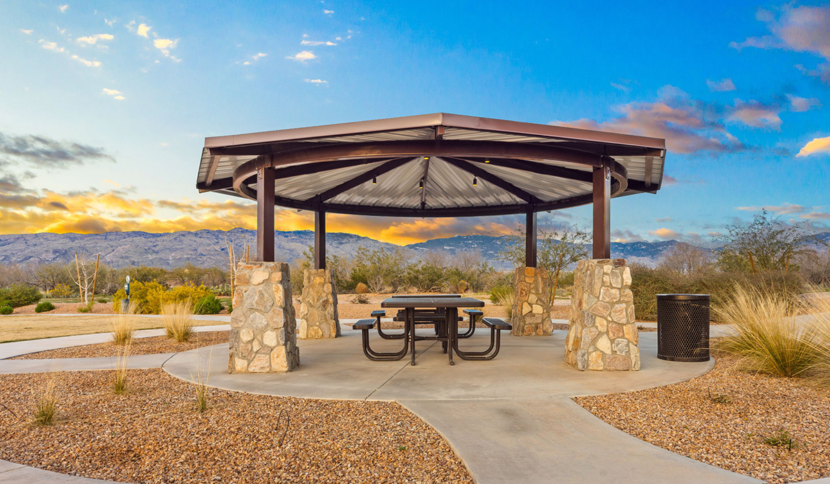 Welcome to The Oasis at Rocking K, a premier D.R. Horton new home community nestled in the picturesque landscapes of Vail, Arizona, where new homes blend seamlessly with the breathtaking surroundings of the Rincon Mountains. Experience the perfect balance of tranquility and modern convenience in this master-planned neighborhood, designed to offer a lifestyle that caters to families, nature enthusiasts, and anyone seeking a peaceful yet connected community.  The Oasis at Rocking K features five beautifully designed one-story floor plans ranging from 1,400 to 1,900 square feet, each crafted with the high-quality features and finishes D.R. Horton is known for. Homes in Rocking K feature a Spanish lace stucco exterior, tile roofs, and meticulously landscaped front yards with auto drip irrigation. Inside, you’ll find luxurious quartz countertops in the kitchens and bathrooms, 42” shaker-style cabinets with modern cabinet pulls, and wood-look tile flooring throughout the main living areas. Homes also include covered front porches and back patios, perfect for enjoying Arizona’s stunning sunsets and clear night skies.  Each home in The Oasis at Rocking K is equipped with D.R. Horton’s Home is Connected® Smart Home package, which includes a smart thermostat, video doorbell, keyless entry, Wi-Fi-enabled garage door opener, and Deako light switches. Additionally, these homes meet the stringent DOE Zero Energy Ready Home standards, making them not only comfortable and modern but also exceptionally energy-efficient. With features like spray foam insulation, tankless water heaters and LED lighting, these homes are designed to reduce your environmental footprint and provide long-term savings on energy costs.  Living at Rocking K means being part of a vibrant, family-oriented community with a strong sense of connection among residents. The Oasis at Rocking K offers a variety of amenities, including ramadas, picnic tables, and grassy areas perfect for gatherings. Residents also have access to the greater Rocking K master-planned neighborhood amenities, such as a splashpad, large event lawn, walking paths, multipurpose fields, basketball and pickleball courts, and an innovative playground with a zip-line and jungle gym. The new K-8 school, set to open in 2025, is just one of the many features that make Rocking K ideal for families.  Life at Rocking K is further enriched by a lively calendar of lifestyle events, thoughtfully organized by the Rocking K Homeowners Association. These events are a cornerstone of community life, fostering a strong sense of connection among residents. Whether you’re looking to enjoy a quiet evening star gazing in the park or engage in fun activities with neighbors, there’s always something happening. The quarterly lifestyle calendar is packed with regular and seasonal events, including movie nights in the park, sports and summer camps for kids, and wine tasting events for adults. Families can join hiking groups, participate in trivia nights, or enjoy the various holiday celebrations. The community comes alive during the holidays with loads of themed events, arts and crafts fairs, and car shows. Rocking K’s commitment to providing a dynamic and engaging environment ensures that there’s always an opportunity to make memories and build lasting friendships right in your neighborhood.   Residents of Rocking K benefit from easy access to I-10, making commutes to Tucson and surrounding areas a breeze. The community is close to major employers such as Davis-Monthan Air Force Base, Raytheon, and the University of Arizona, as well as top-notch healthcare facilities like TMC Rincon and Northwest Hospital East. The nearby Houghton Town Center and Houghton Rd. business corridor offer convenient shopping, dining, and services.  For outdoor enthusiasts, Rocking K is surrounded by natural beauty and recreational opportunities. Explore the hiking and biking trails at Colossal Cave Mountain Park, Saguaro National Park East, and the Arizona Trail. Enjoy golfing at Del Lago Golf Course, or take a short drive to Sonoita for a day trip to Arizona’s Wine Country. Whether it’s hiking, camping, or simply taking in the stunning views, Rocking K is your gateway to the great outdoors.  With 360-degree mountain views, calm and quiet evenings, and a location that’s close to everything you need, Rocking K is truly a community where you can thrive. Experience the best of Arizona living at The Oasis at Rocking K, where your new home awaits in a community that offers everything you need for a fulfilling lifestyle.