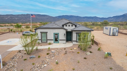 Welcome to The Oasis at Rocking K, a premier D.R. Horton new home community nestled in the picturesque landscapes of Vail, Arizona, where new homes blend seamlessly with the breathtaking surroundings of the Rincon Mountains. Experience the perfect balance of tranquility and modern convenience in this master-planned neighborhood, designed to offer a lifestyle that caters to families, nature enthusiasts, and anyone seeking a peaceful yet connected community. The Oasis at Rocking K features five beautifully designed one-story floor plans ranging from 1,400 to 1,900 square feet, each crafted with the high-quality features and finishes D.R. Horton is known for. Homes in Rocking K feature a Spanish lace stucco exterior, tile roofs, and meticulously landscaped front yards with auto drip irrigation. Inside, you’ll find luxurious quartz countertops in the kitchens and bathrooms, 42” shaker-style cabinets with modern cabinet pulls, and wood-look tile flooring throughout the main living areas. Homes also include covered front porches and back patios, perfect for enjoying Arizona’s stunning sunsets and clear night skies. Each home in The Oasis at Rocking K is equipped with D.R. Horton’s Home is Connected® Smart Home package, which includes a smart thermostat, video doorbell, keyless entry, Wi-Fi-enabled garage door opener, and Deako light switches. Additionally, these homes meet the stringent DOE Zero Energy Ready Home standards, making them not only comfortable and modern but also exceptionally energy-efficient. With features like spray foam insulation, tankless water heaters and LED lighting, these homes are designed to reduce your environmental footprint and provide long-term savings on energy costs. Living at Rocking K means being part of a vibrant, family-oriented community with a strong sense of connection among residents. The Oasis at Rocking K offers a variety of amenities, including ramadas, picnic tables, and grassy areas perfect for gatherings. Residents also have access to the greater Rocking K master-planned neighborhood amenities, such as a splashpad, large event lawn, walking paths, multipurpose fields, basketball and pickleball courts, and an innovative playground with a zip-line and jungle gym. The new K-8 school, set to open in 2025, is just one of the many features that make Rocking K ideal for families. Life at Rocking K is further enriched by a lively calendar of lifestyle events, thoughtfully organized by the Rocking K Homeowners Association. These events are a cornerstone of community life, fostering a strong sense of connection among residents. Whether you’re looking to enjoy a quiet evening star gazing in the park or engage in fun activities with neighbors, there’s always something happening. The quarterly lifestyle calendar is packed with regular and seasonal events, including movie nights in the park, sports and summer camps for kids, and wine tasting events for adults. Families can join hiking groups, participate in trivia nights, or enjoy the various holiday celebrations. The community comes alive during the holidays with loads of themed events, arts and crafts fairs, and car shows. Rocking K’s commitment to providing a dynamic and engaging environment ensures that there’s always an opportunity to make memories and build lasting friendships right in your neighborhood. Residents of Rocking K benefit from easy access to I-10, making commutes to Tucson and surrounding areas a breeze. The community is close to major employers such as Davis-Monthan Air Force Base, Raytheon, and the University of Arizona, as well as top-notch healthcare facilities like TMC Rincon and Northwest Hospital East. The nearby Houghton Town Center and Houghton Rd. business corridor offer convenient shopping, dining, and services. For outdoor enthusiasts, Rocking K is surrounded by natural beauty and recreational opportunities. Explore the hiking and biking trails at Colossal Cave Mountain Park, Saguaro National Park East, and the Arizona Trail. Enjoy golfing at Del Lago Golf Course, or take a short drive to Sonoita for a day trip to Arizona’s Wine Country. Whether it’s hiking, camping, or simply taking in the stunning views, Rocking K is your gateway to the great outdoors. With 360-degree mountain views, calm and quiet evenings, and a location that’s close to everything you need, Rocking K is truly a community where you can thrive. Experience the best of Arizona living at The Oasis at Rocking K, where your new home awaits in a community that offers everything you need for a fulfilling lifestyle.