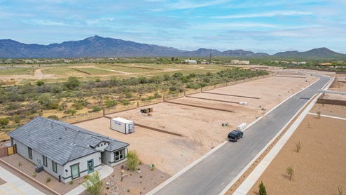 Welcome to The Oasis at Rocking K, a premier D.R. Horton new home community nestled in the picturesque landscapes of Vail, Arizona, where new homes blend seamlessly with the breathtaking surroundings of the Rincon Mountains. Experience the perfect balance of tranquility and modern convenience in this master-planned neighborhood, designed to offer a lifestyle that caters to families, nature enthusiasts, and anyone seeking a peaceful yet connected community. The Oasis at Rocking K features five beautifully designed one-story floor plans ranging from 1,400 to 1,900 square feet, each crafted with the high-quality features and finishes D.R. Horton is known for. Homes in Rocking K feature a Spanish lace stucco exterior, tile roofs, and meticulously landscaped front yards with auto drip irrigation. Inside, you’ll find luxurious quartz countertops in the kitchens and bathrooms, 42” shaker-style cabinets with modern cabinet pulls, and wood-look tile flooring throughout the main living areas. Homes also include covered front porches and back patios, perfect for enjoying Arizona’s stunning sunsets and clear night skies. Each home in The Oasis at Rocking K is equipped with D.R. Horton’s Home is Connected® Smart Home package, which includes a smart thermostat, video doorbell, keyless entry, Wi-Fi-enabled garage door opener, and Deako light switches. Additionally, these homes meet the stringent DOE Zero Energy Ready Home standards, making them not only comfortable and modern but also exceptionally energy-efficient. With features like spray foam insulation, tankless water heaters and LED lighting, these homes are designed to reduce your environmental footprint and provide long-term savings on energy costs. Living at Rocking K means being part of a vibrant, family-oriented community with a strong sense of connection among residents. The Oasis at Rocking K offers a variety of amenities, including ramadas, picnic tables, and grassy areas perfect for gatherings. Residents also have access to the greater Rocking K master-planned neighborhood amenities, such as a splashpad, large event lawn, walking paths, multipurpose fields, basketball and pickleball courts, and an innovative playground with a zip-line and jungle gym. The new K-8 school, set to open in 2025, is just one of the many features that make Rocking K ideal for families. Life at Rocking K is further enriched by a lively calendar of lifestyle events, thoughtfully organized by the Rocking K Homeowners Association. These events are a cornerstone of community life, fostering a strong sense of connection among residents. Whether you’re looking to enjoy a quiet evening star gazing in the park or engage in fun activities with neighbors, there’s always something happening. The quarterly lifestyle calendar is packed with regular and seasonal events, including movie nights in the park, sports and summer camps for kids, and wine tasting events for adults. Families can join hiking groups, participate in trivia nights, or enjoy the various holiday celebrations. The community comes alive during the holidays with loads of themed events, arts and crafts fairs, and car shows. Rocking K’s commitment to providing a dynamic and engaging environment ensures that there’s always an opportunity to make memories and build lasting friendships right in your neighborhood. Residents of Rocking K benefit from easy access to I-10, making commutes to Tucson and surrounding areas a breeze. The community is close to major employers such as Davis-Monthan Air Force Base, Raytheon, and the University of Arizona, as well as top-notch healthcare facilities like TMC Rincon and Northwest Hospital East. The nearby Houghton Town Center and Houghton Rd. business corridor offer convenient shopping, dining, and services. For outdoor enthusiasts, Rocking K is surrounded by natural beauty and recreational opportunities. Explore the hiking and biking trails at Colossal Cave Mountain Park, Saguaro National Park East, and the Arizona Trail. Enjoy golfing at Del Lago Golf Course, or take a short drive to Sonoita for a day trip to Arizona’s Wine Country. Whether it’s hiking, camping, or simply taking in the stunning views, Rocking K is your gateway to the great outdoors. With 360-degree mountain views, calm and quiet evenings, and a location that’s close to everything you need, Rocking K is truly a community where you can thrive. Experience the best of Arizona living at The Oasis at Rocking K, where your new home awaits in a community that offers everything you need for a fulfilling lifestyle.