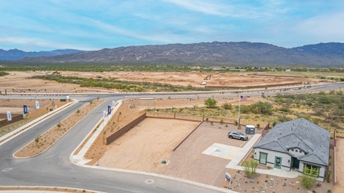 Welcome to The Oasis at Rocking K, a premier D.R. Horton new home community nestled in the picturesque landscapes of Vail, Arizona, where new homes blend seamlessly with the breathtaking surroundings of the Rincon Mountains. Experience the perfect balance of tranquility and modern convenience in this master-planned neighborhood, designed to offer a lifestyle that caters to families, nature enthusiasts, and anyone seeking a peaceful yet connected community. The Oasis at Rocking K features five beautifully designed one-story floor plans ranging from 1,400 to 1,900 square feet, each crafted with the high-quality features and finishes D.R. Horton is known for. Homes in Rocking K feature a Spanish lace stucco exterior, tile roofs, and meticulously landscaped front yards with auto drip irrigation. Inside, you’ll find luxurious quartz countertops in the kitchens and bathrooms, 42” shaker-style cabinets with modern cabinet pulls, and wood-look tile flooring throughout the main living areas. Homes also include covered front porches and back patios, perfect for enjoying Arizona’s stunning sunsets and clear night skies. Each home in The Oasis at Rocking K is equipped with D.R. Horton’s Home is Connected® Smart Home package, which includes a smart thermostat, video doorbell, keyless entry, Wi-Fi-enabled garage door opener, and Deako light switches. Additionally, these homes meet the stringent DOE Zero Energy Ready Home standards, making them not only comfortable and modern but also exceptionally energy-efficient. With features like spray foam insulation, tankless water heaters and LED lighting, these homes are designed to reduce your environmental footprint and provide long-term savings on energy costs. Living at Rocking K means being part of a vibrant, family-oriented community with a strong sense of connection among residents. The Oasis at Rocking K offers a variety of amenities, including ramadas, picnic tables, and grassy areas perfect for gatherings. Residents also have access to the greater Rocking K master-planned neighborhood amenities, such as a splashpad, large event lawn, walking paths, multipurpose fields, basketball and pickleball courts, and an innovative playground with a zip-line and jungle gym. The new K-8 school, set to open in 2025, is just one of the many features that make Rocking K ideal for families. Life at Rocking K is further enriched by a lively calendar of lifestyle events, thoughtfully organized by the Rocking K Homeowners Association. These events are a cornerstone of community life, fostering a strong sense of connection among residents. Whether you’re looking to enjoy a quiet evening star gazing in the park or engage in fun activities with neighbors, there’s always something happening. The quarterly lifestyle calendar is packed with regular and seasonal events, including movie nights in the park, sports and summer camps for kids, and wine tasting events for adults. Families can join hiking groups, participate in trivia nights, or enjoy the various holiday celebrations. The community comes alive during the holidays with loads of themed events, arts and crafts fairs, and car shows. Rocking K’s commitment to providing a dynamic and engaging environment ensures that there’s always an opportunity to make memories and build lasting friendships right in your neighborhood. Residents of Rocking K benefit from easy access to I-10, making commutes to Tucson and surrounding areas a breeze. The community is close to major employers such as Davis-Monthan Air Force Base, Raytheon, and the University of Arizona, as well as top-notch healthcare facilities like TMC Rincon and Northwest Hospital East. The nearby Houghton Town Center and Houghton Rd. business corridor offer convenient shopping, dining, and services. For outdoor enthusiasts, Rocking K is surrounded by natural beauty and recreational opportunities. Explore the hiking and biking trails at Colossal Cave Mountain Park, Saguaro National Park East, and the Arizona Trail. Enjoy golfing at Del Lago Golf Course, or take a short drive to Sonoita for a day trip to Arizona’s Wine Country. Whether it’s hiking, camping, or simply taking in the stunning views, Rocking K is your gateway to the great outdoors. With 360-degree mountain views, calm and quiet evenings, and a location that’s close to everything you need, Rocking K is truly a community where you can thrive. Experience the best of Arizona living at The Oasis at Rocking K, where your new home awaits in a community that offers everything you need for a fulfilling lifestyle.